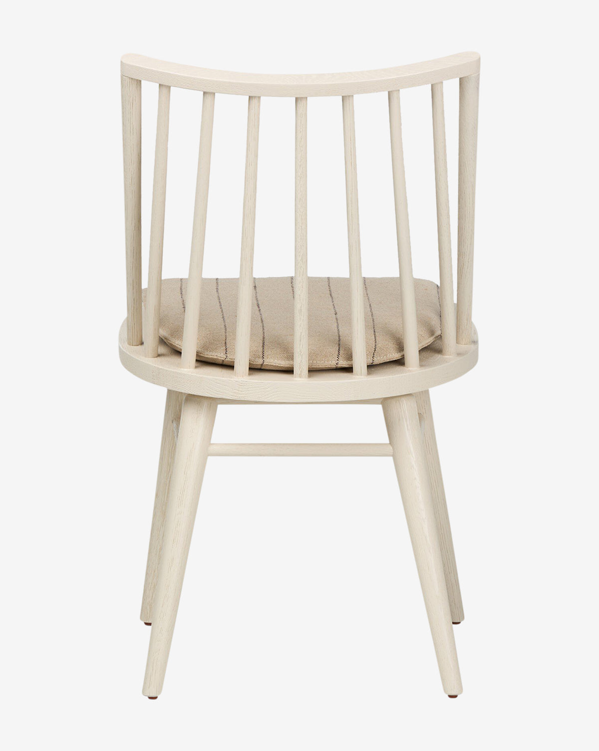 The Madison Dining Chair features a contemporary Windsor design with a curved spindle backrest, four angled oak legs, and a round beige cushioned seat, shown against a white background by McGee & Co.