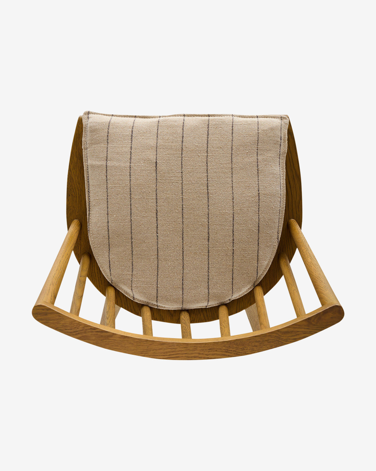 The Madison Dining Chair is a wooden rocking chair with a curved base and horizontal slats, inspired by the classic Windsor design. It includes a beige cushion with thin dark vertical stripes and is photographed against a white background by McGee & Co.
