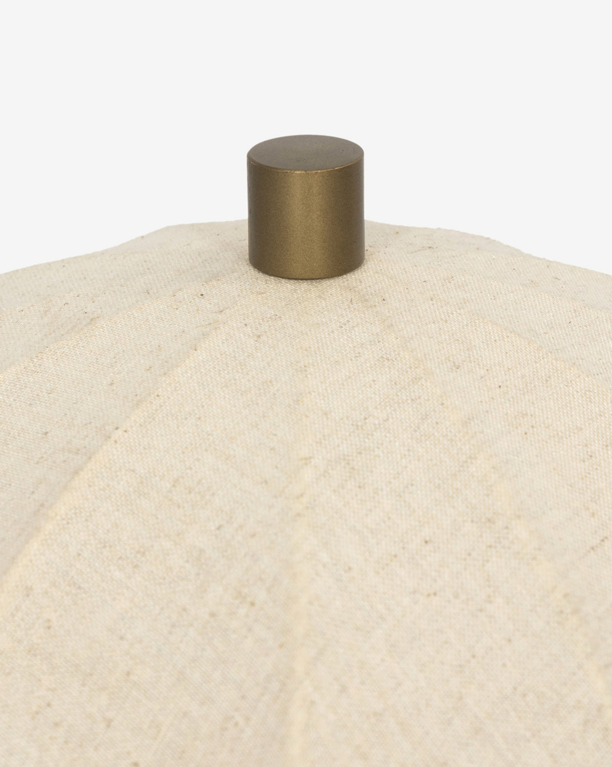 Close-up of the Malinska Table Lamp, showcasing its taupe marble base and textured beige fabric lampshade, topped with a round metallic knob against a white background, by McGee & Co.