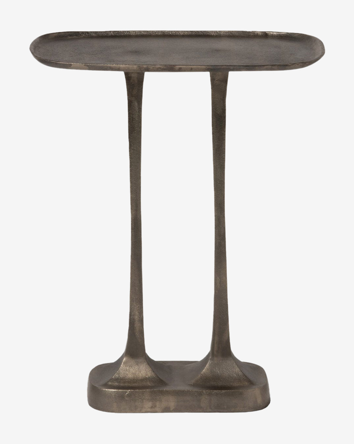 The Manzo Accent Table is a small, minimalist piece with an oval top, two narrow legs, and a rectangular base. Its rustic, textured metal finish gives it a striking industrial look—perfect as an accent in modern spaces, by McGee & Co.