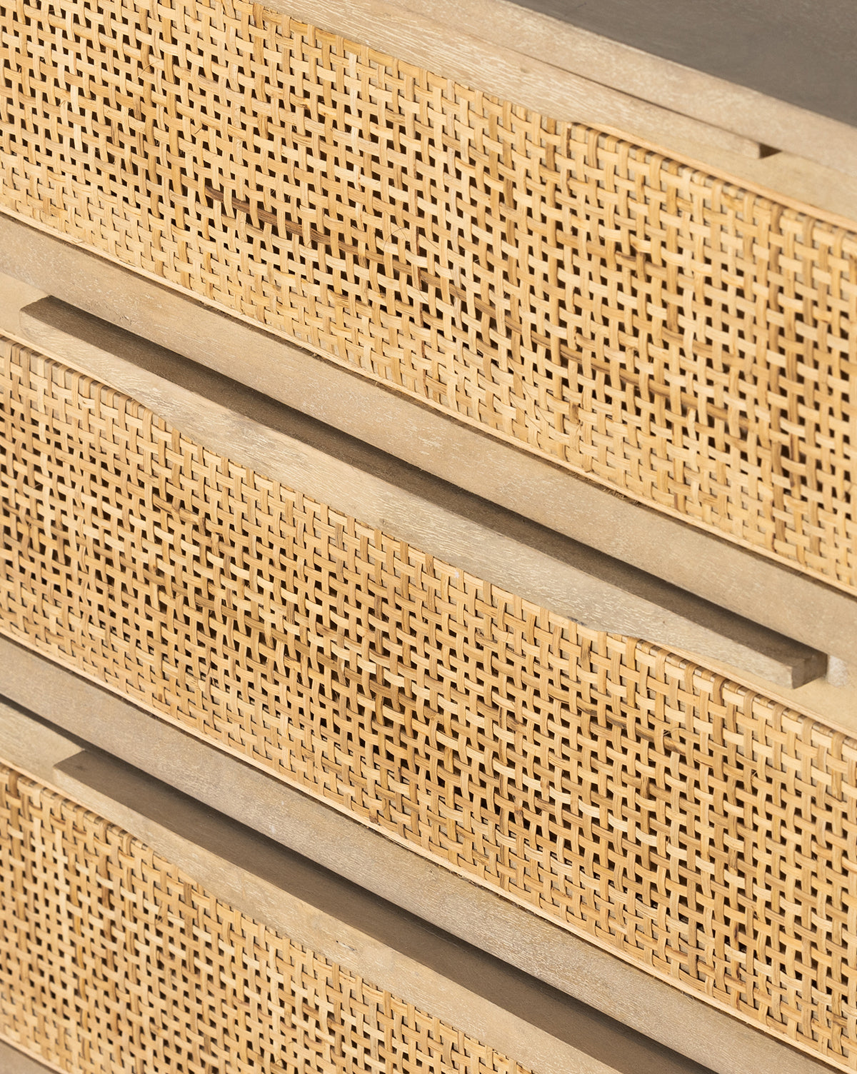 Close-up of the Margaery Nightstand, featuring woven cane details, rattan drawer fronts, and horizontal recessed handles that emphasize its texture and natural materials, by McGee & Co.