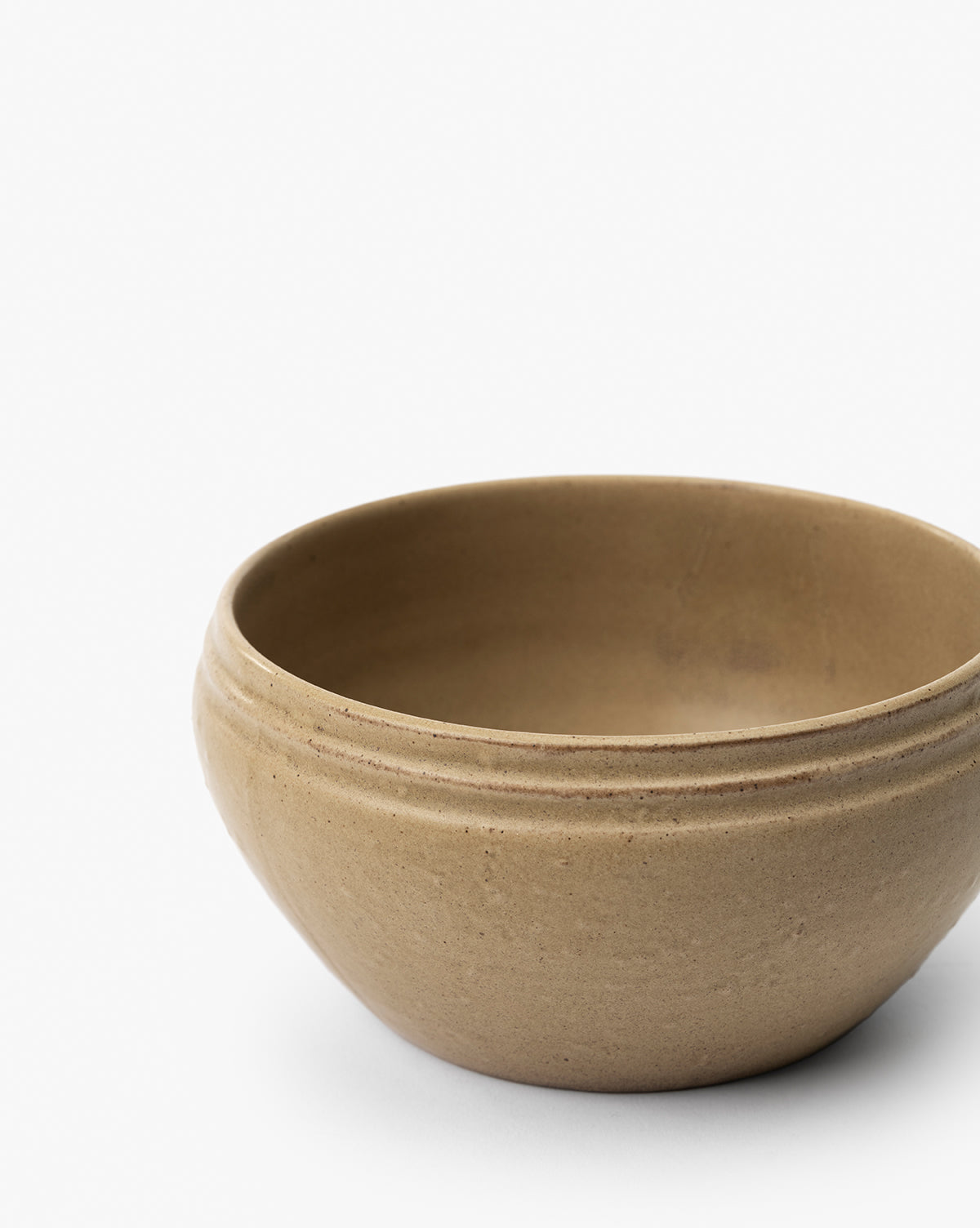 The Mariella Stoneware Bowls (Set of 4) feature a plain, round beige design with subtle horizontal grooves near the rim and an organic texture, displayed against a white background by McGee & Co.
