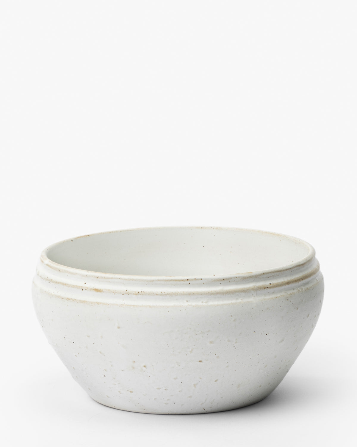 The Mariella Stoneware Bowls (Set of 4) feature a simple round design in white, with a slightly organic texture and three subtle ridges near the rim, shown on a plain white background by McGee & Co.