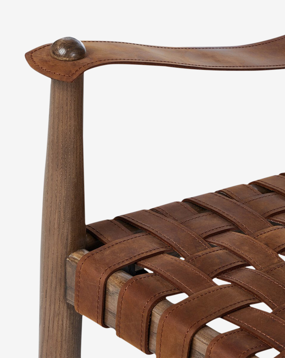 Close-up of the Maris Lounge Chair showcases its woven brown top-grain leather seat and armrest, emphasizing vintage-inspired craftsmanship and rich textures, by McGee & Co.