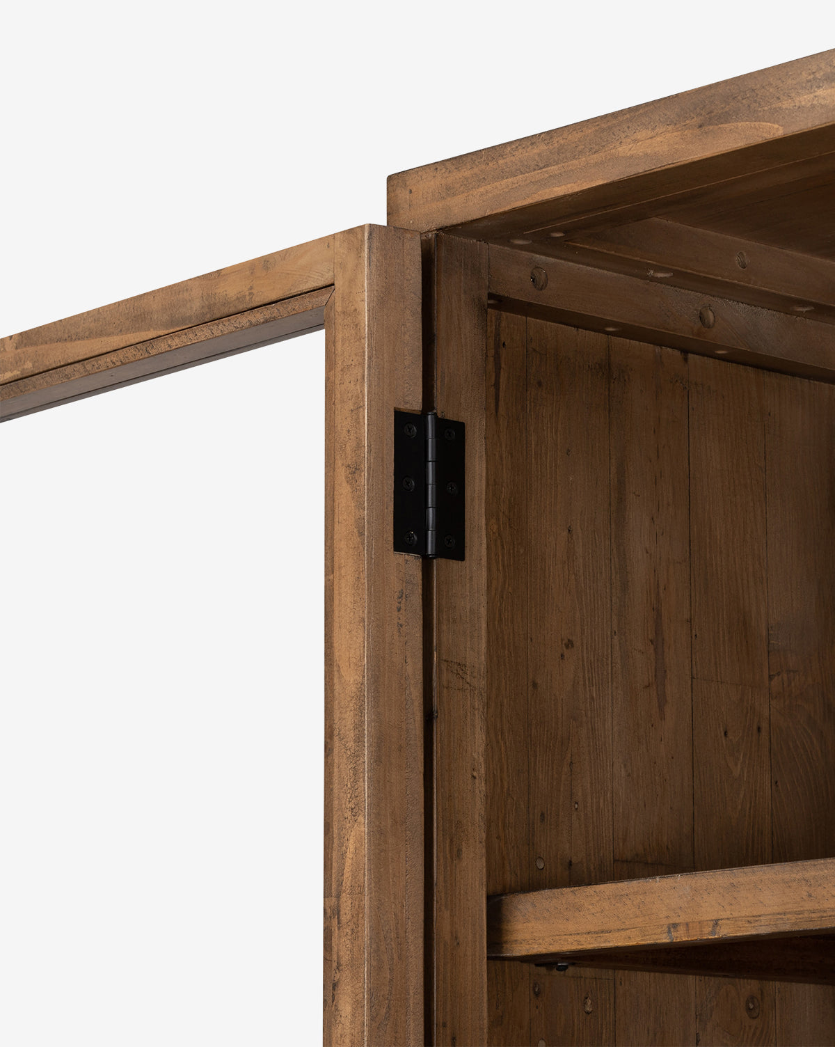 Close-up of the Maverick Cabinet’s top corner with an open door, featuring black iron hardware, an interior shelf, and natural-finish reclaimed pine with visible grain and knots, by McGee & Co.