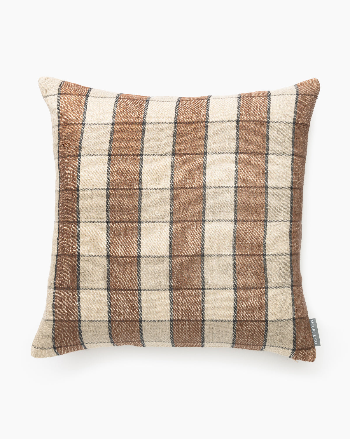 The Maxine Pillow Cover is a square throw pillow with a beige and brown plaid pattern accented by thin black lines. Its woven, textured cover has a small fabric tag on one side and is shown against a white background by McGee & Co.