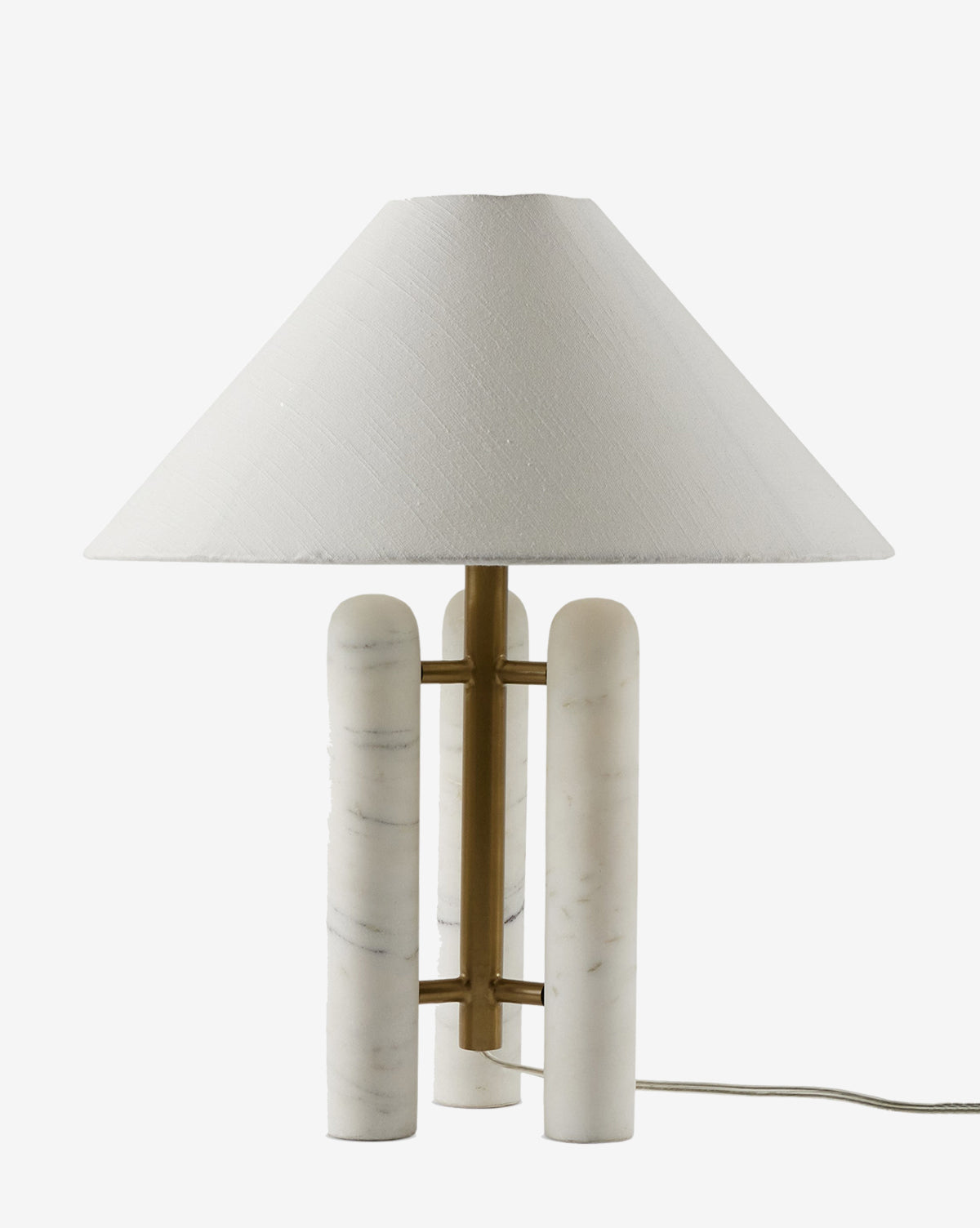 The Medici Table Lamp showcases a decorative design with a wide white fabric shade, solid marble column base joined by brass rods, and an exposed cord, by McGee & Co.
