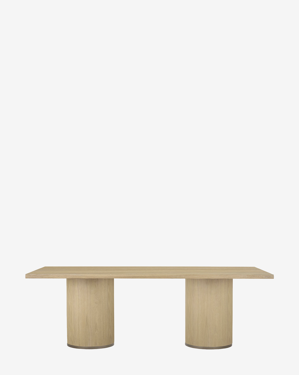 The Mellette Dining Table is a modern rectangular oak table with a smooth surface and two wide cylindrical pedestal legs, displayed against a plain white background by McGee & Co.