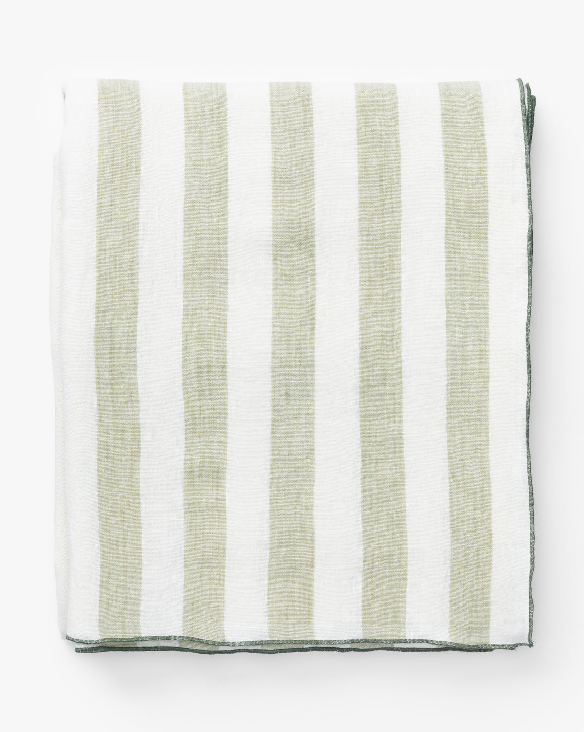 The Melrose Striped Tablecloth, featuring vertical green and white stripes and a darker border, is neatly folded on a white surface, highlighting the charm of this handwoven piece, by McGee & Co.
