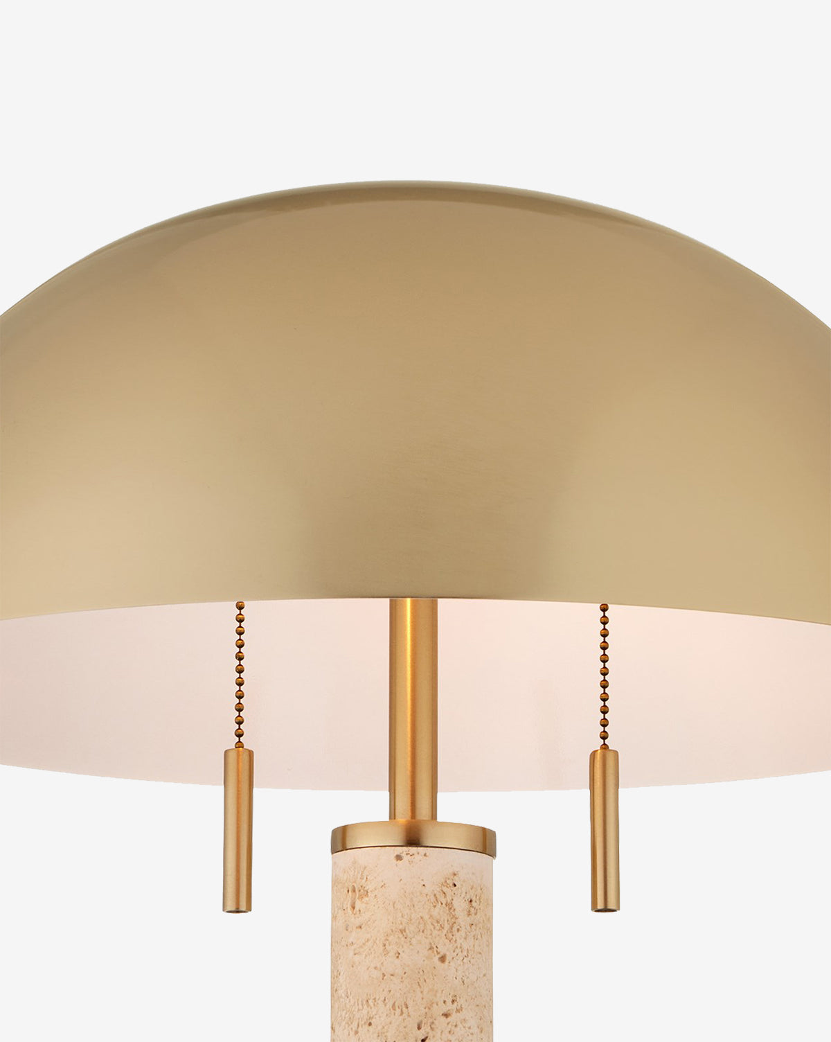 Close-up of the Miles Table Lamp, featuring a cylindrical natural travertine base, dome-shaped gold metal shade, and twin pull chains, set against a plain white background by McGee & Co.
