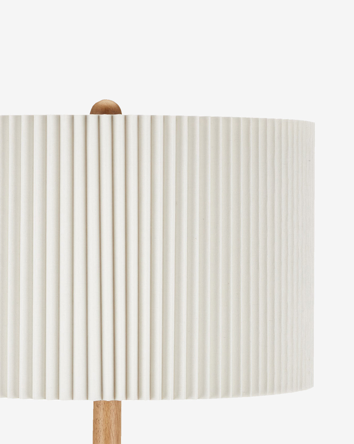 Close-up of the Mitford Floor Lamp with a white, bone linen pleated shade and natural wood base and finial, shown against a plain white background by McGee & Co.
