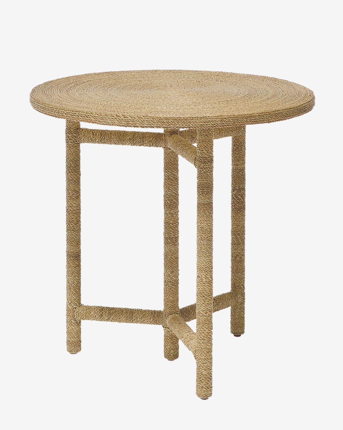 The Moody Side Table is a round seagrass side table crafted from woven natural fibers, featuring four straight legs and a minimalist textured design, by McGee & Co.