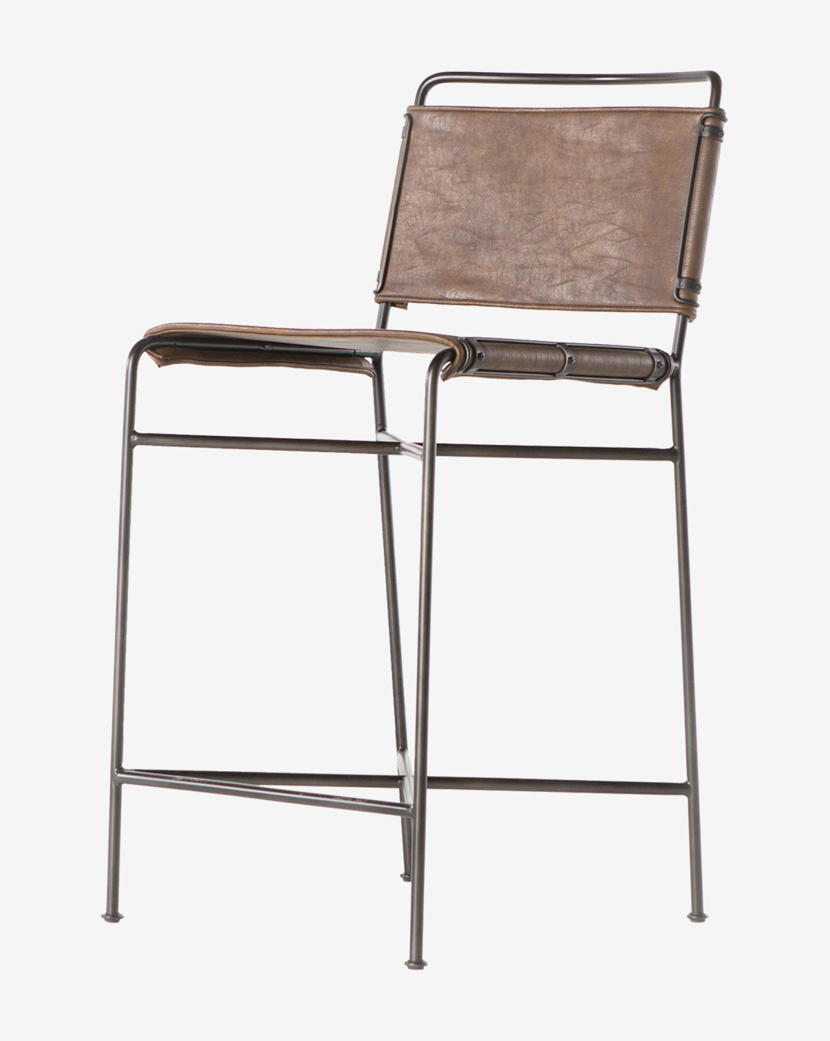 The Moore Stool features a tall, slim metal frame with brown leather seat and backrest in a minimalist industrial design, by McGee & Co. Shown against a plain white background.