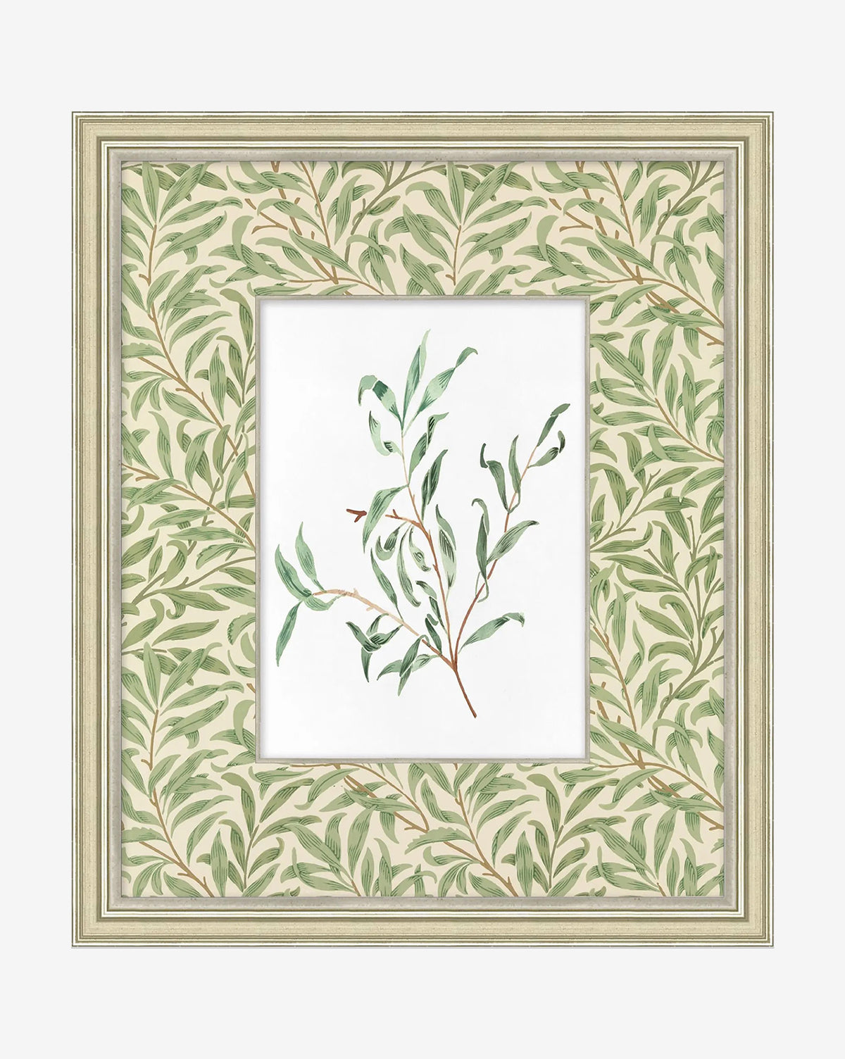 The Morris Icon III is a gallery-quality framed artwork featuring a watercolor of leafy green branches, set against a wide mat with matching soft green leafy patterns, and enclosed in a light wood frame by McGee & Co.