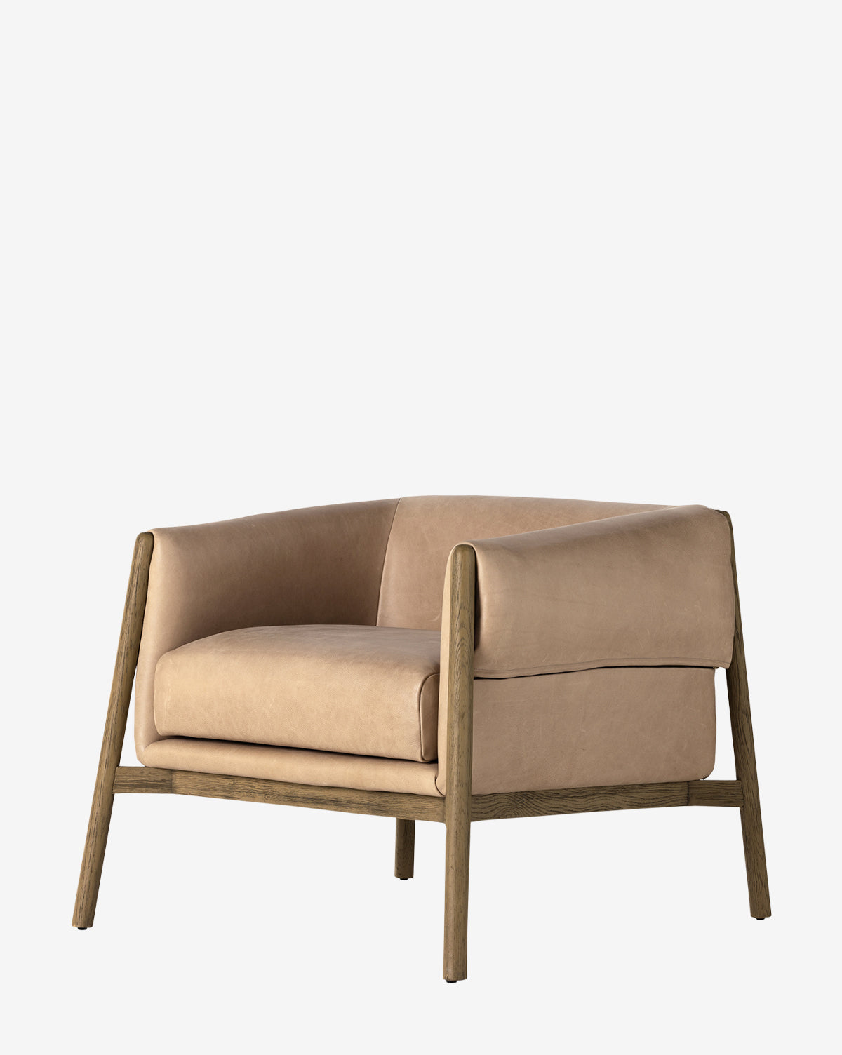 The Nadine Lounge Chair is a modern armchair with tan leather upholstery and a minimalistic solid oak frame, featuring wide armrests and a boxy design, shown against a plain white background, by McGee & Co.