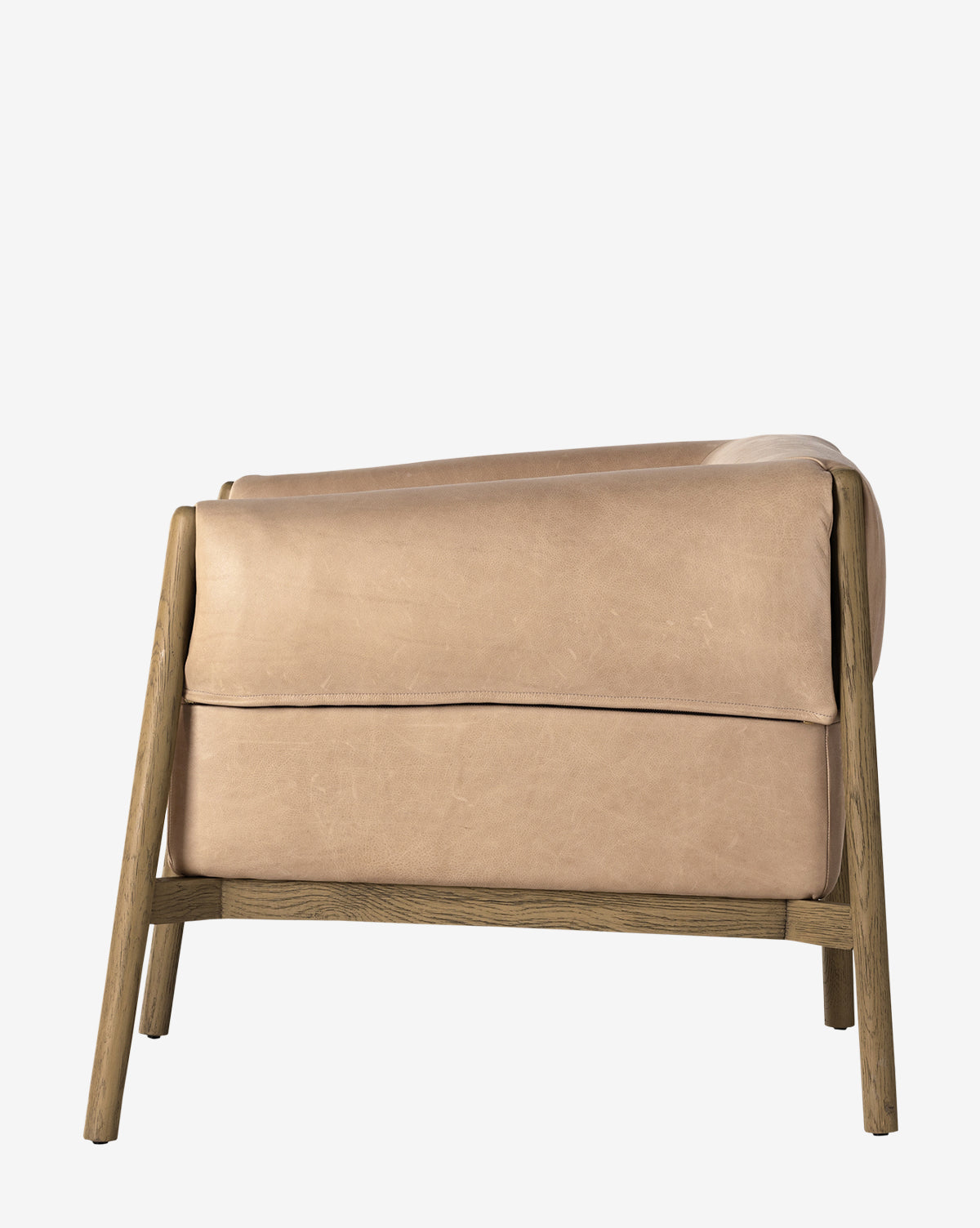 The Nadine Lounge Chair features a light brown leather seat and backrest on an angular solid oak frame, shown from the back against a white background, by McGee & Co.