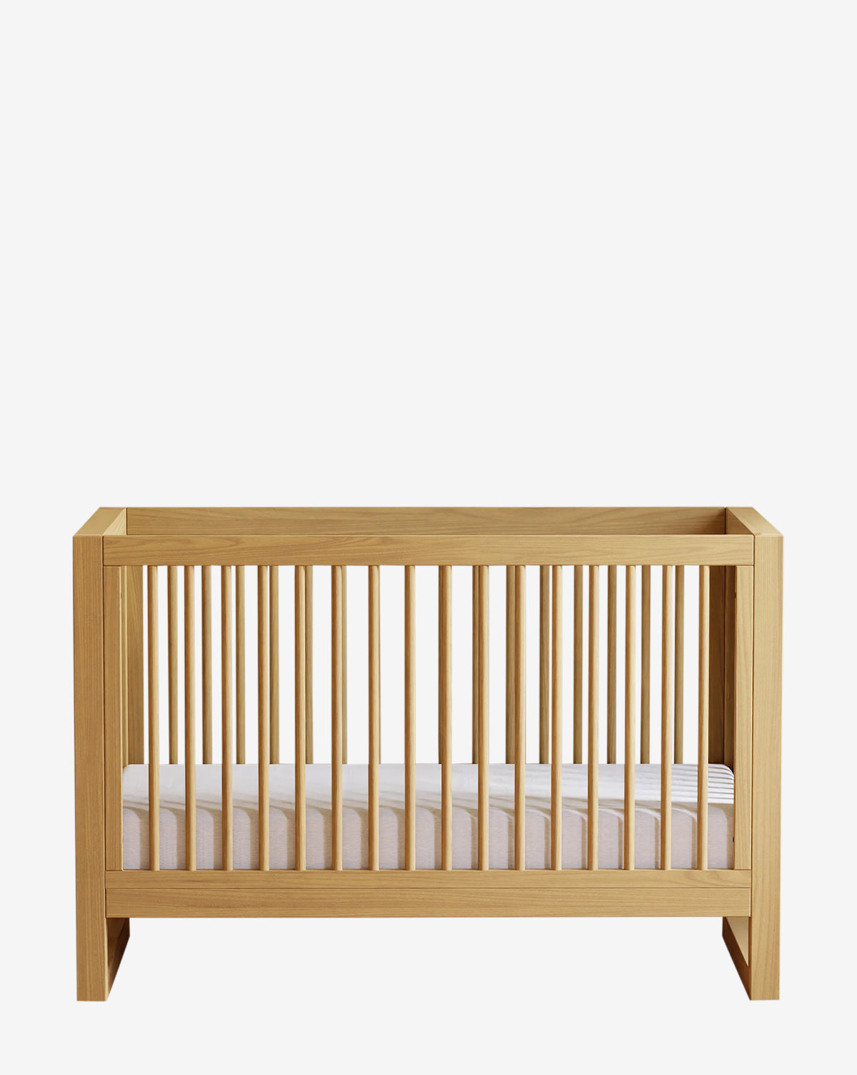 The Nantucket 3-in-1 Convertible Crib with Toddler Bed Conversion Kit, made from solid pine with vertical slats and a white mattress, is displayed against a plain white background by McGee & Co.