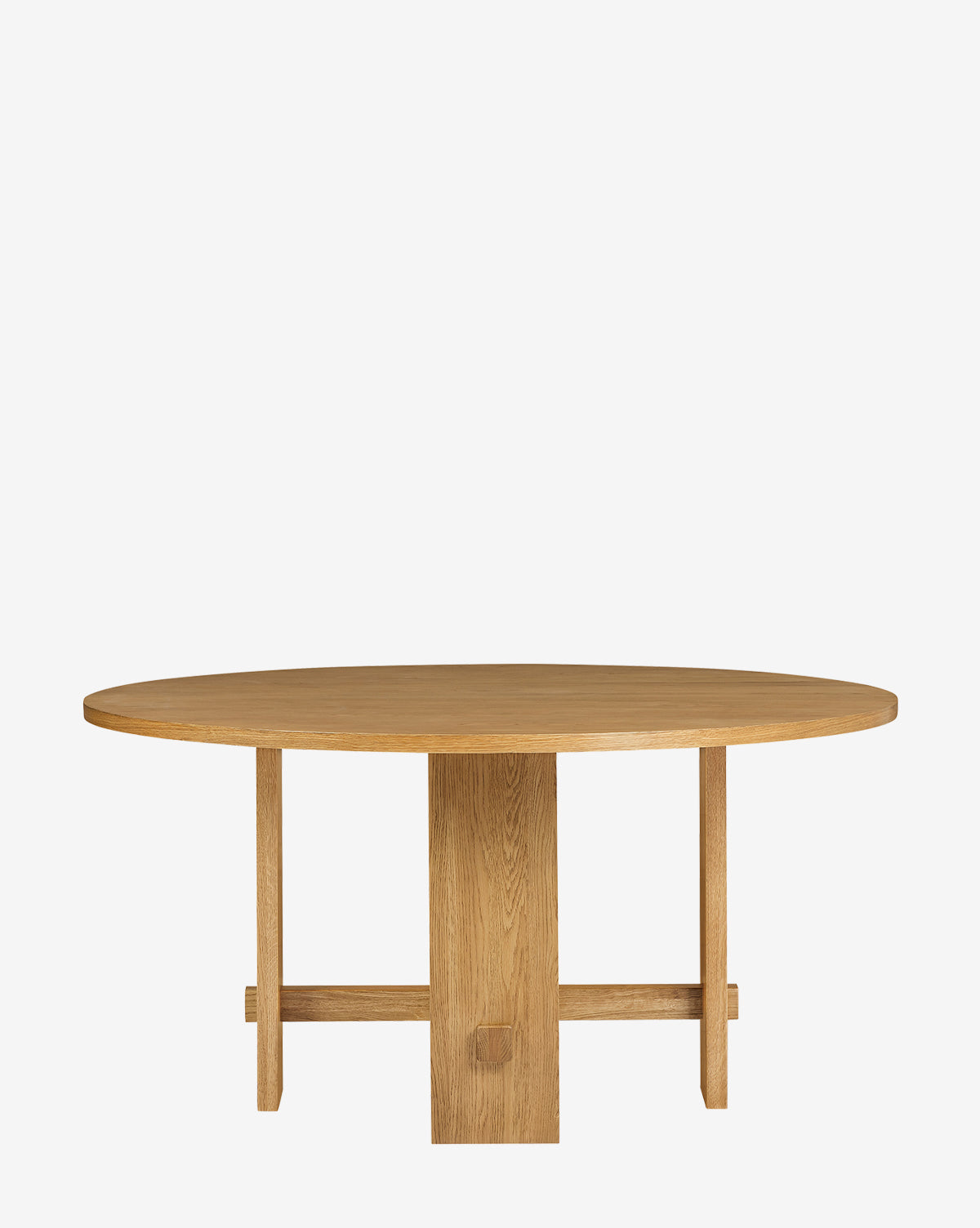 The Newbold Dining Table is a round oak table with a smooth surface and central pedestal base extending into four legs, finished in warm honey and shown against a white background by McGee & Co.