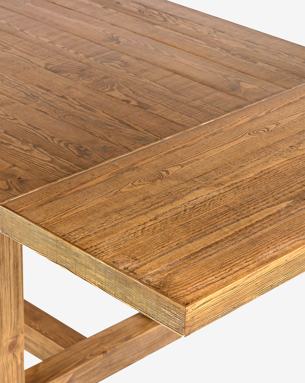 Close-up view of the Niran Extension Dining Table’s corner, featuring a natural finish that highlights the wood grain. Crafted from solid pine, this table has clean edges, sturdy construction, and a smooth surface by McGee & Co.