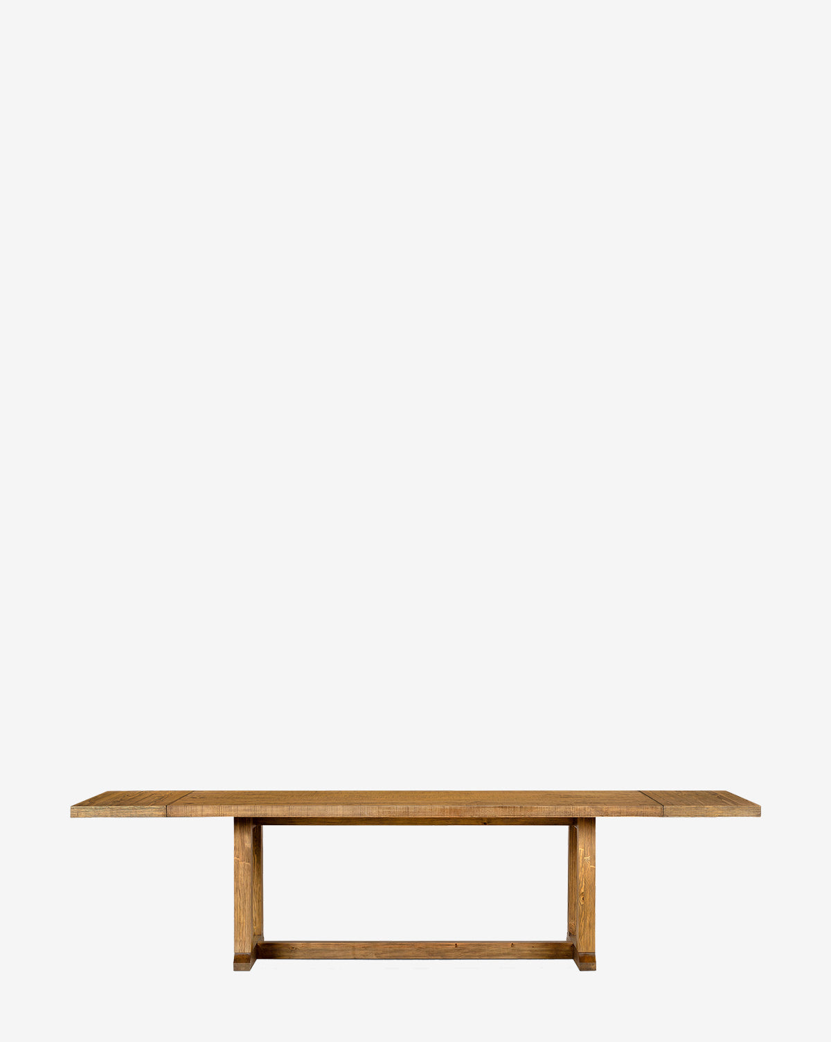 The Niran Extension Dining Table, a long rectangular solid pine piece with a simple design and sturdy legs, is displayed against a plain white background by McGee & Co.