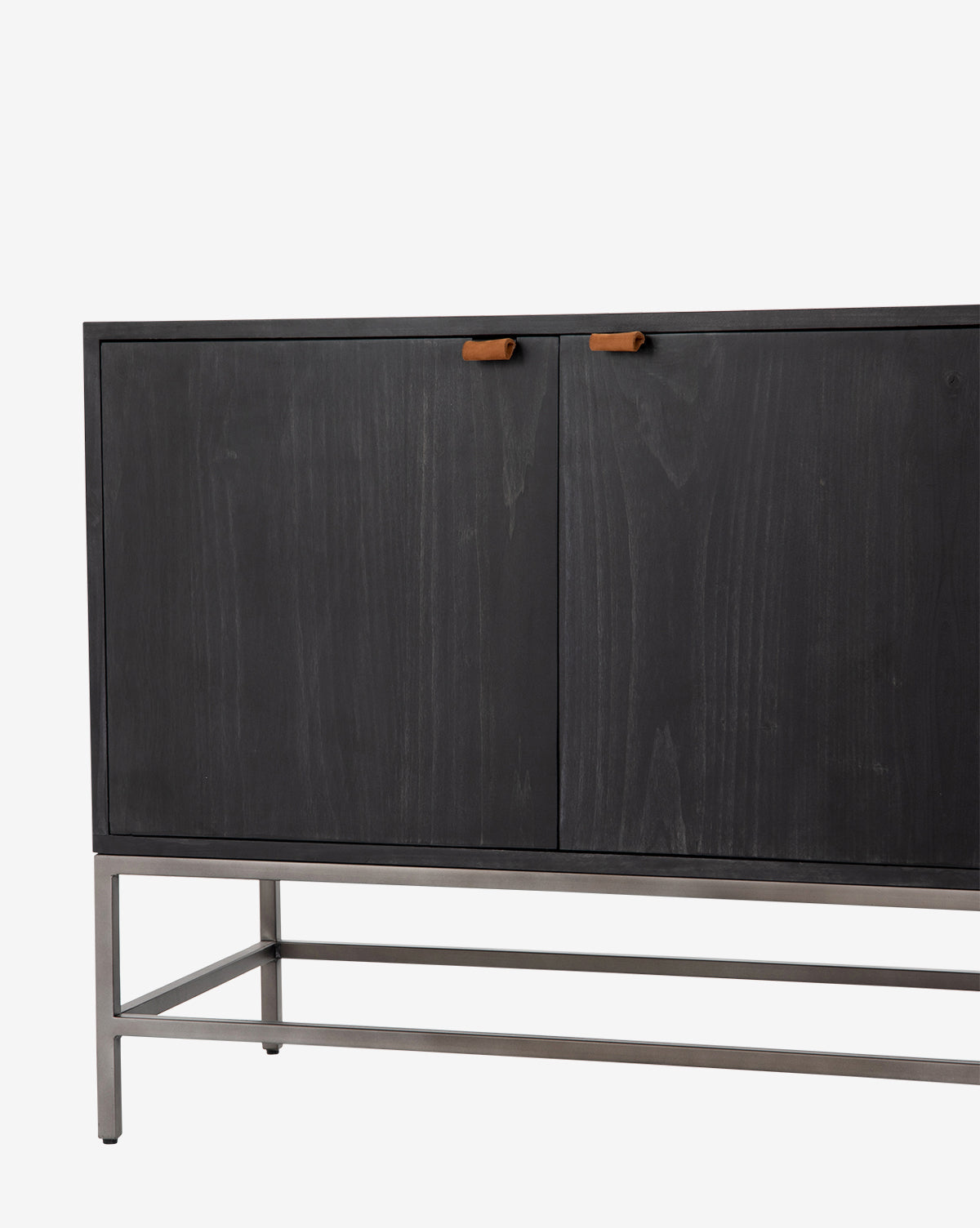 The Noland Sideboard is a sleek black wooden cabinet featuring hidden storage, two doors with brown leather handles, and a minimalist metal frame base, shown against a plain white background by McGee & Co.