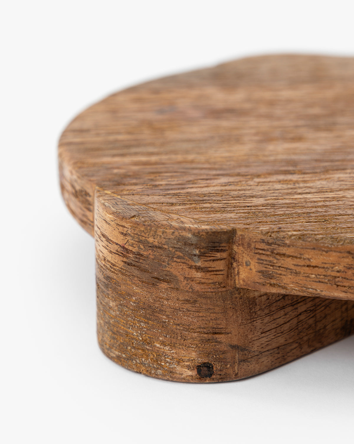 Close-up of the Norfolk Wood Pedestal, a round, rustic mango wood board with a textured, visible grain—ideal for displaying plants or use as a food-safe serving pedestal—shown on a white background, by McGee & Co.
