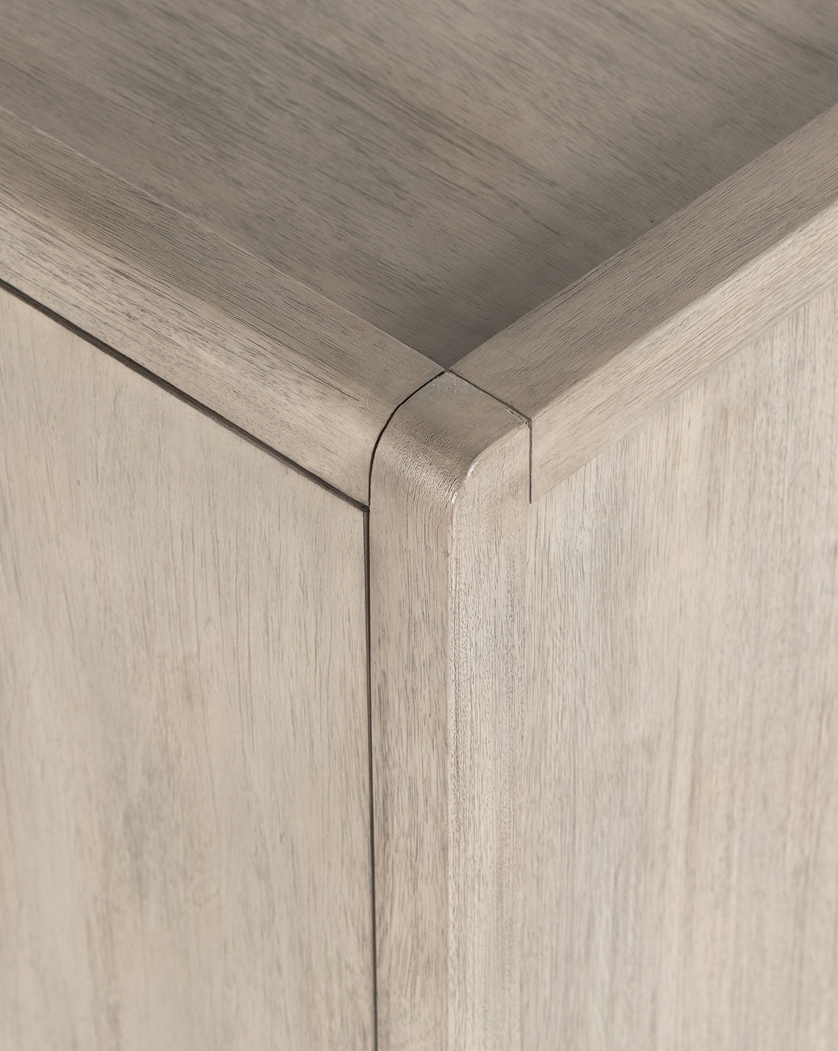 Close-up of the Nyx Sideboards corner, highlighting its smooth, rounded edges and natural wood grain, with versatile storage thanks to adjustable interior shelving, by McGee & Co.