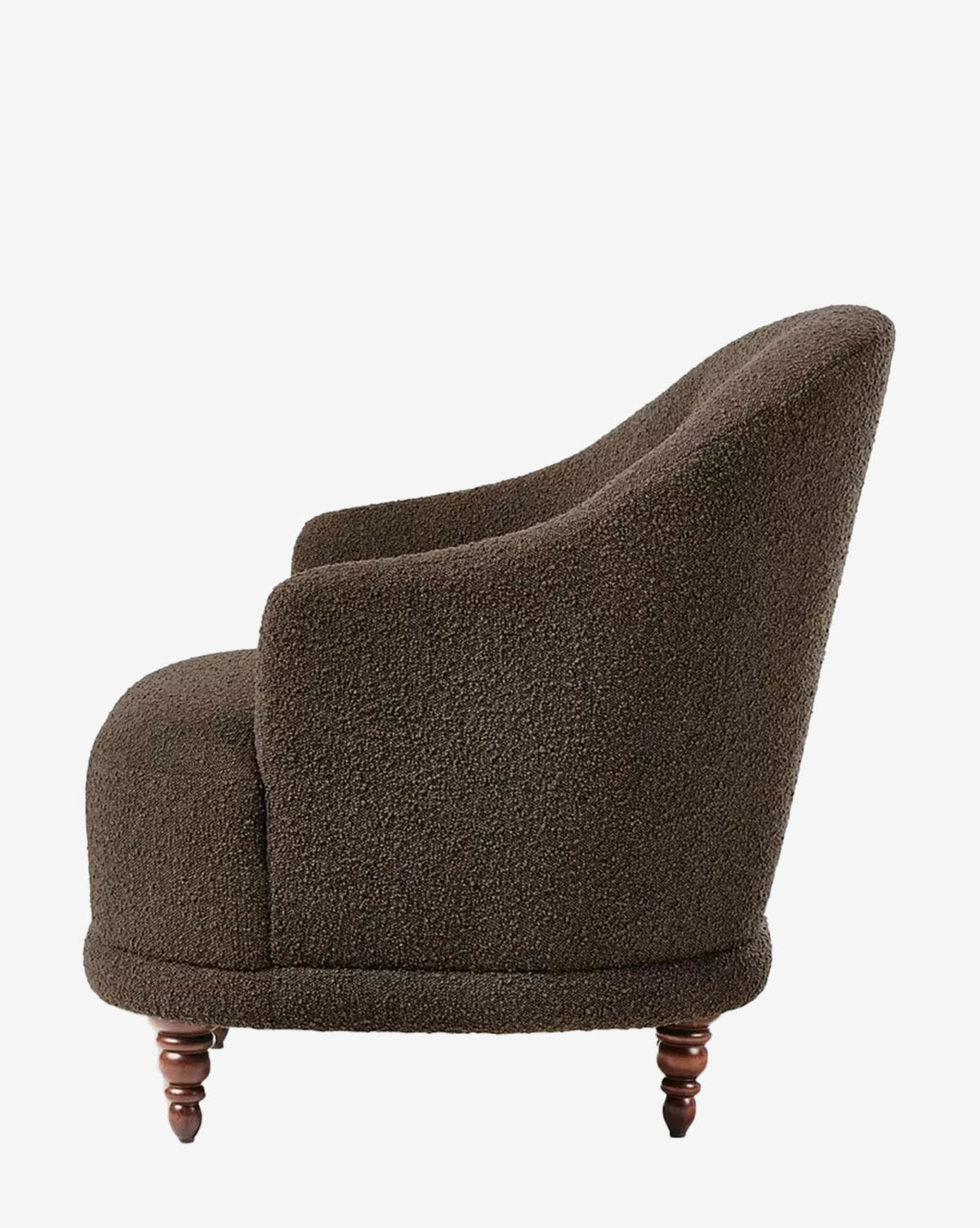 A side view of the Olivette Slipper Chair, featuring dark brown textured velvet upholstery, a rounded back and seat, and short turned wooden legs, displayed against a plain white background by McGee & Co.