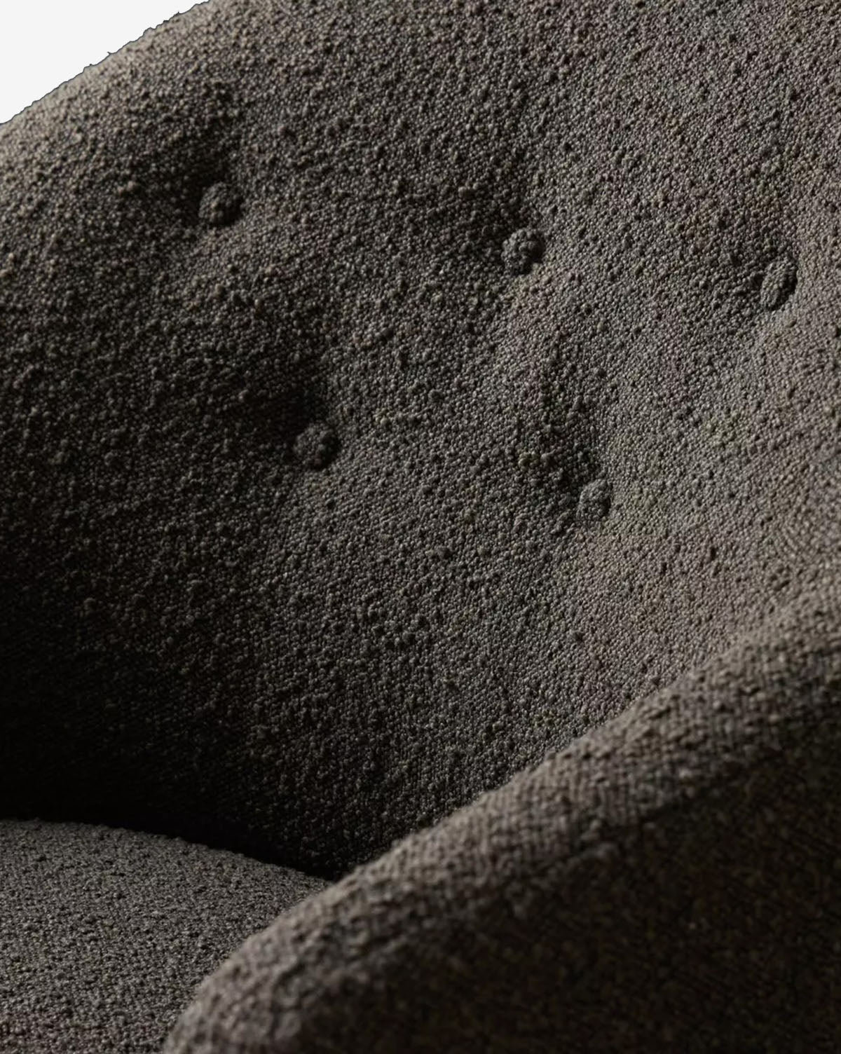 Close-up of the Olivette Slipper Chair in dark gray, featuring textured upholstery, tufted backrest, and curved armrests for a sophisticated blend of traditional and modern style, by McGee & Co.