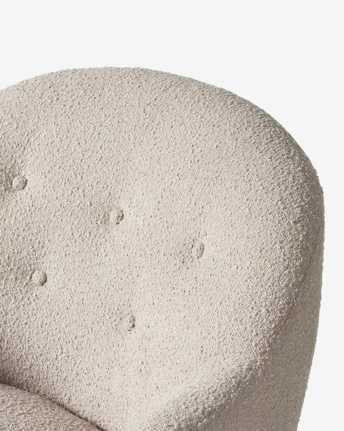 Close-up of the light beige, textured backrest of the Olivette Slipper Chair, featuring four fabric-covered buttons in a subtle diamond pattern, by McGee & Co.