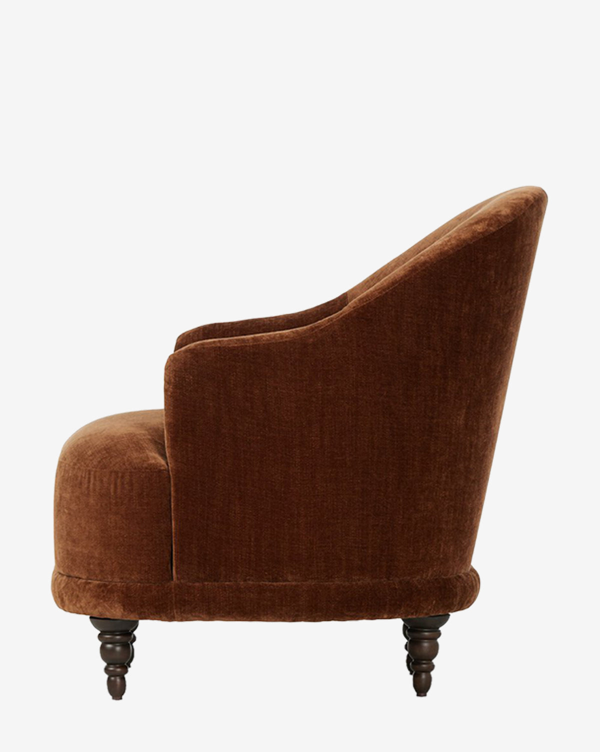 A side view of the Olivette Slipper Chair, an accent chair upholstered in brown velvet with wooden legs, curved backrest, and plush cushioning, shown against a plain white background by McGee & Co.