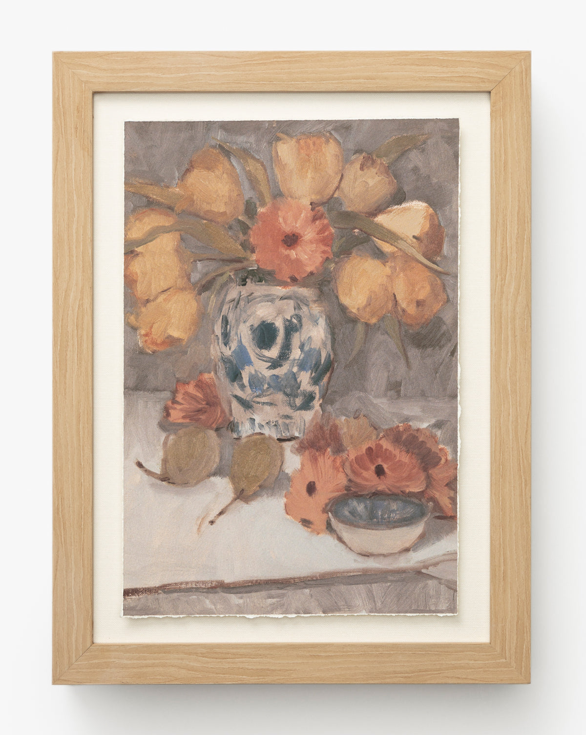 Orange Florals Still Life is a framed watercolor artwork featuring yellow tulips, orange flowers in a blue and white vase, figs, scattered orange florals, and a small bowl, all depicted in soft, muted colors with an impressionistic style, by McGee & Co.