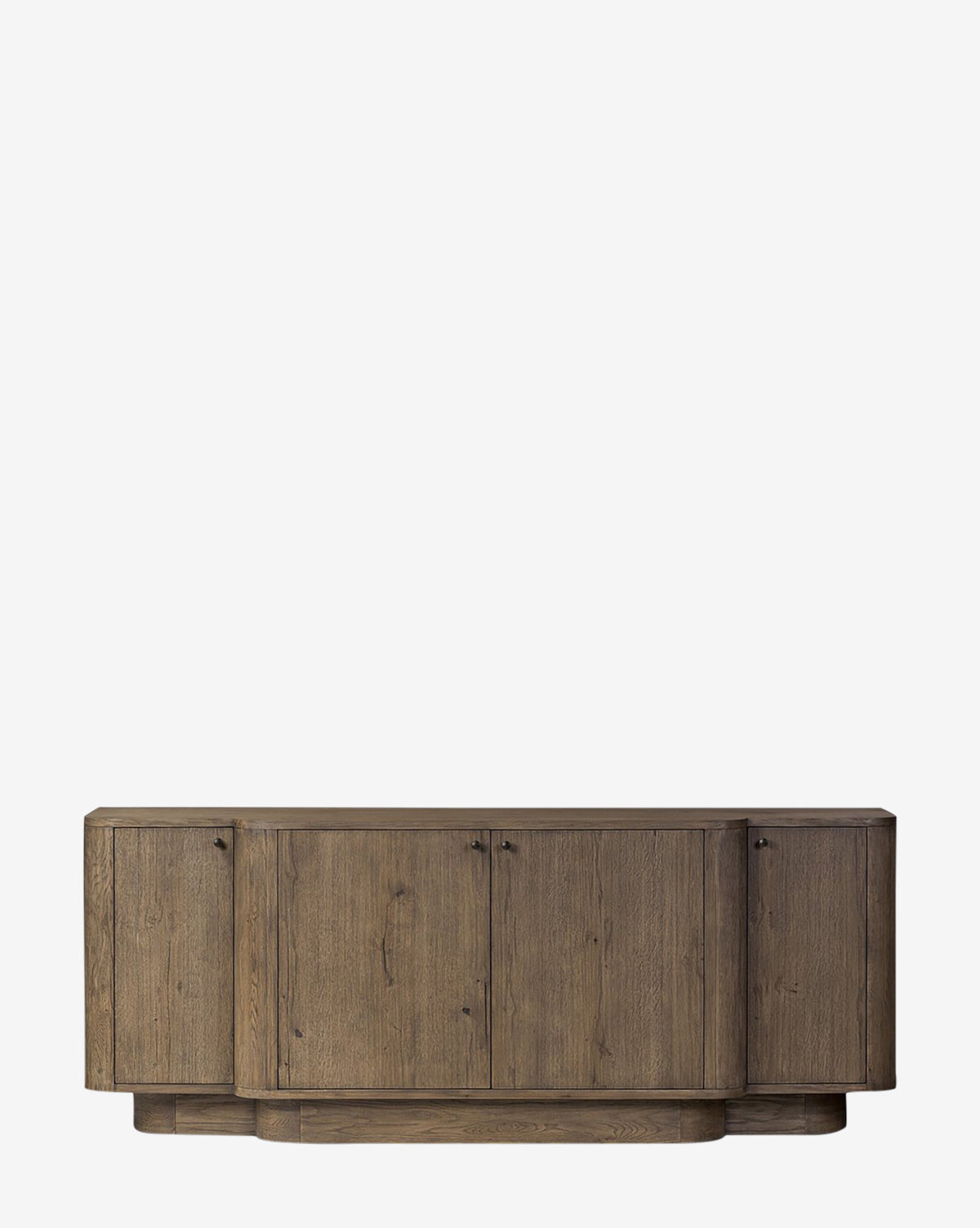 The Oswin Sideboard features a natural brown, weathered oak finish with a break-front design, four cabinet doors, visible wood grain, a smooth surface, and a raised base for generous storage in a minimalist modern style, by McGee & Co.