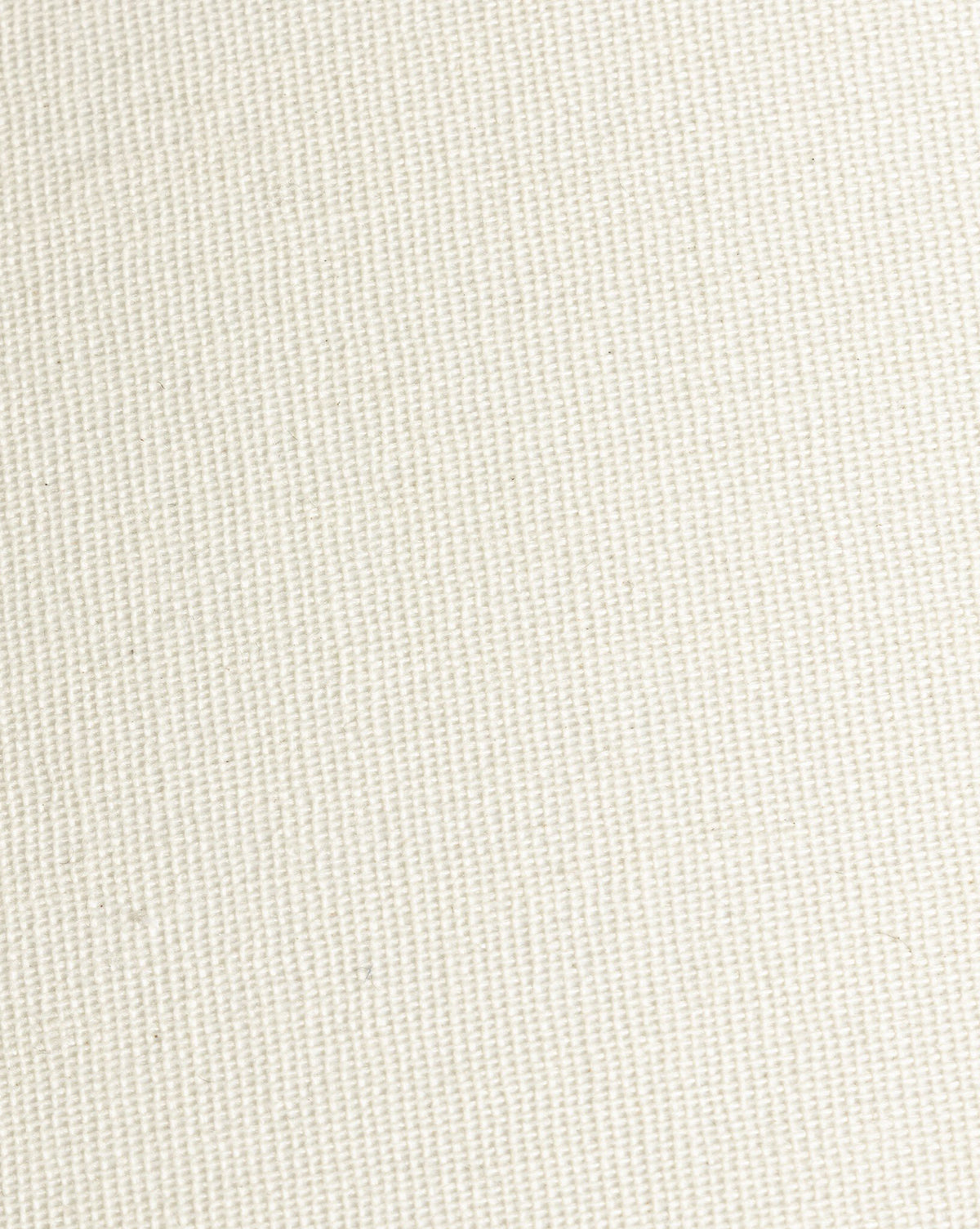 Close-up of a plain, off-white canvas fabric with a diagonal woven texture—similar to the ivory linen shade on the Parma Table Lamp, by McGee & Co.