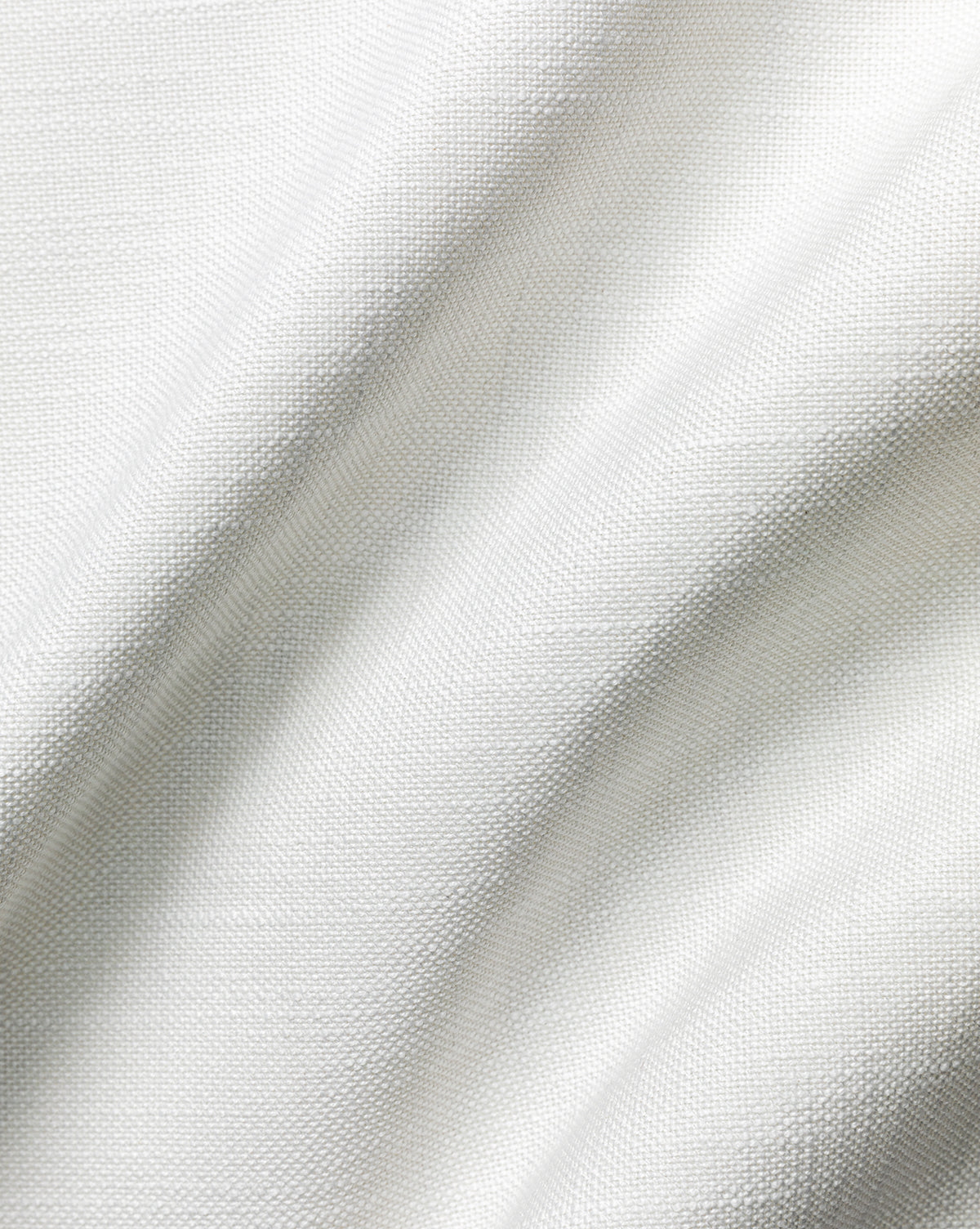 Close-up of the Pasadena Performance Weave Swatch, showcasing its white fabric with a visible weave pattern and gentle folds that create soft shadows and texture, by McGee & Co.