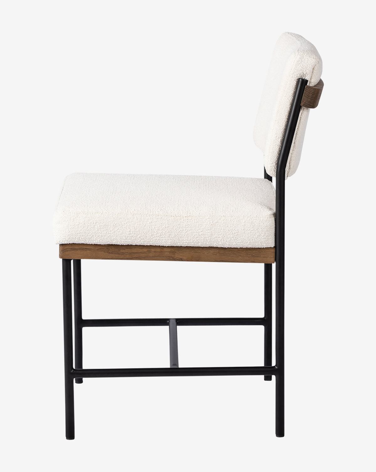 Side view of the Pascal Dining Chair with a black steel and wood frame, wooden accents, and thick off-white cushions on the seat and backrest, styled against a plain white background by McGee & Co.