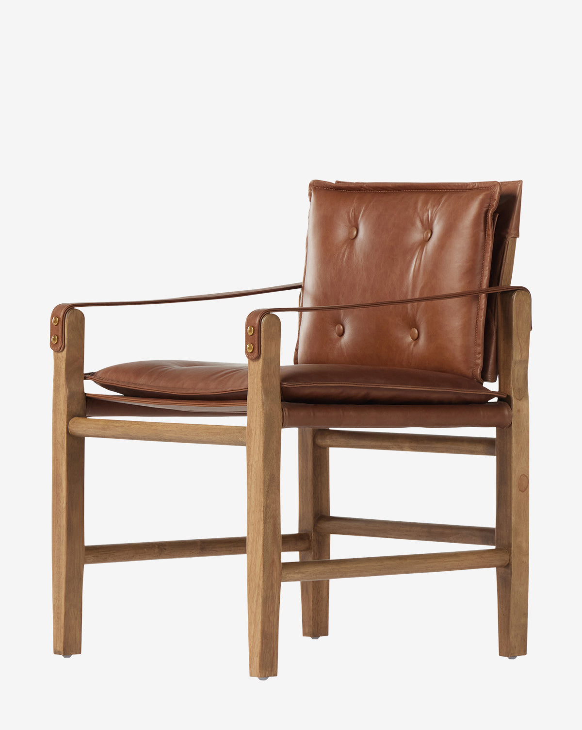 The Pederson Dining Armchair features a honey-finished wood frame, top grain leather seat and backrest cushions, leather armrests, button tufting, and a minimalist design, by McGee & Co.