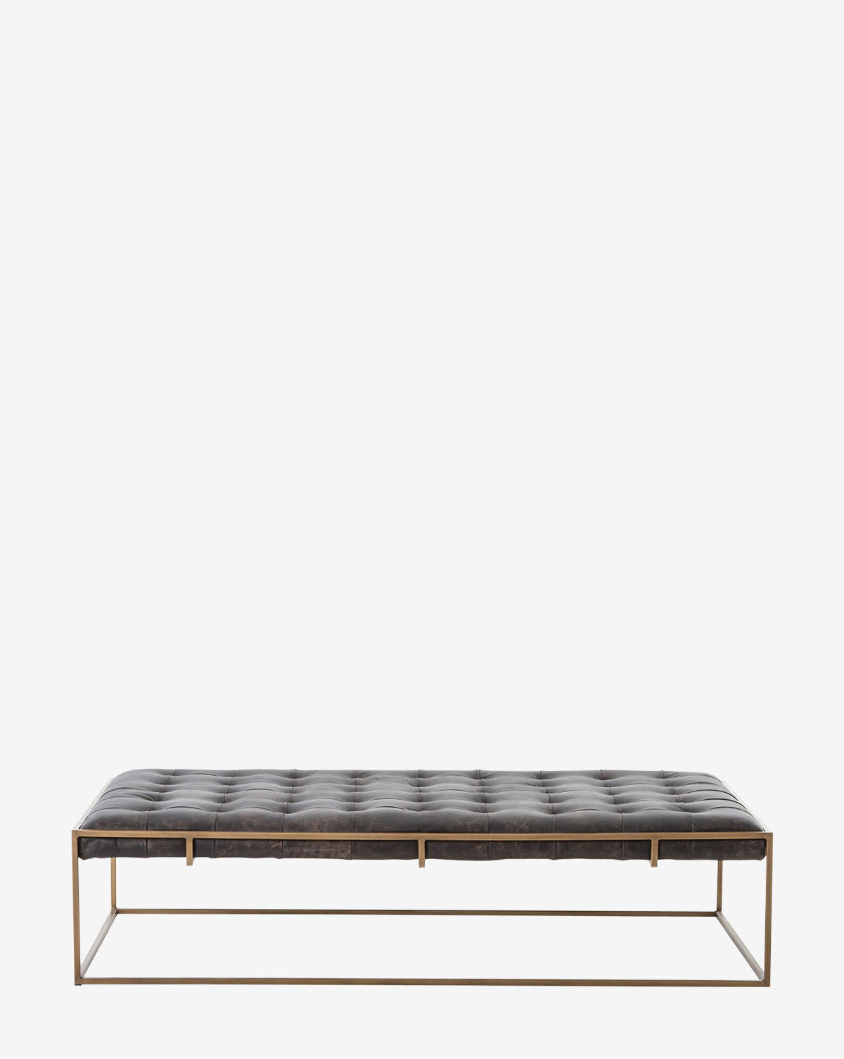 The Penn Coffee Table features a tufted black top-grain leather cushion and a minimalist antique brass metal frame, showcased against a plain white background, by McGee & Co.