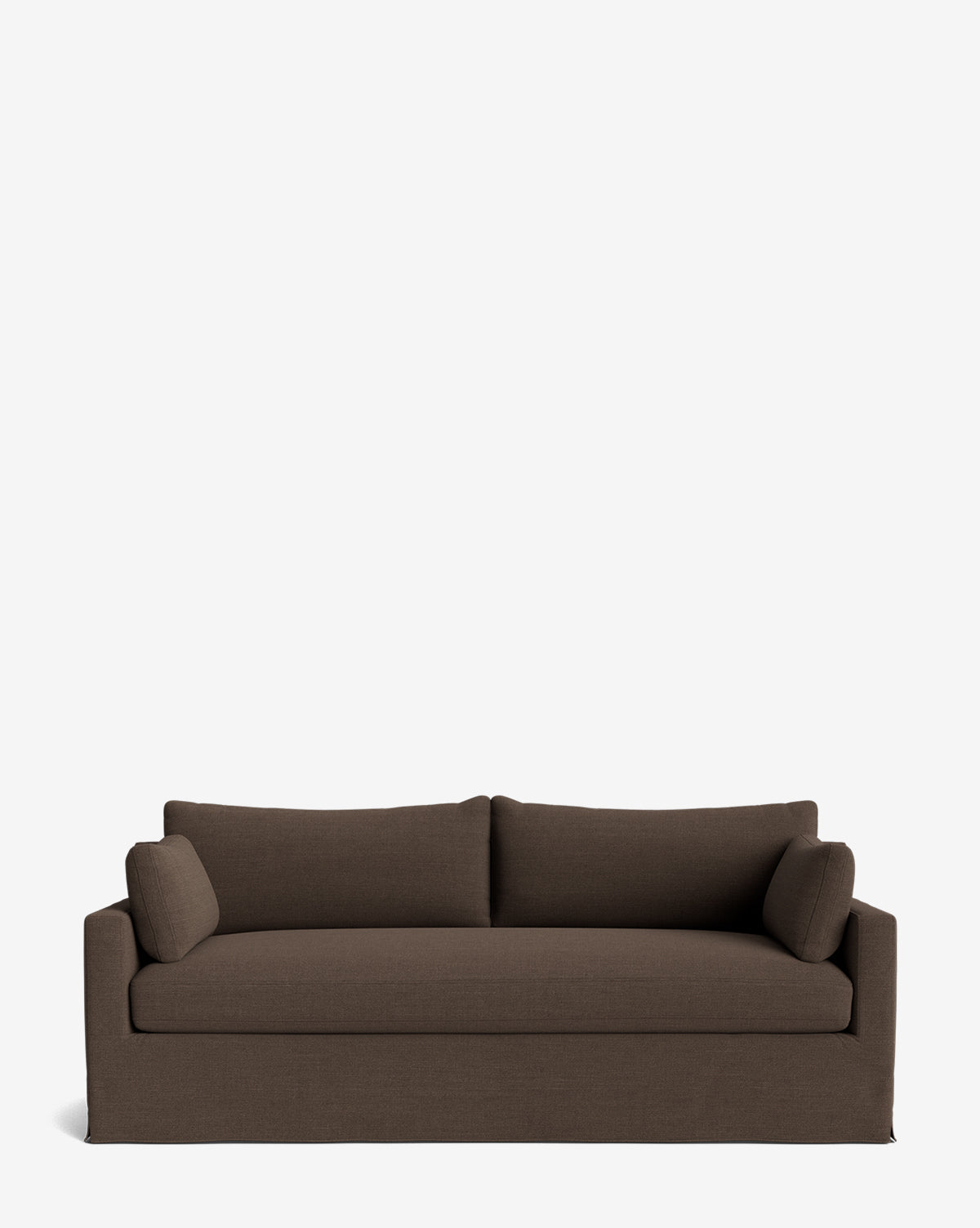 A brown Peterson Classic Slipcover Sofa (75-100) with feather blend cushions, two seat and back cushions, and two cylindrical side pillows, displayed against a plain white background by McGee & Co.