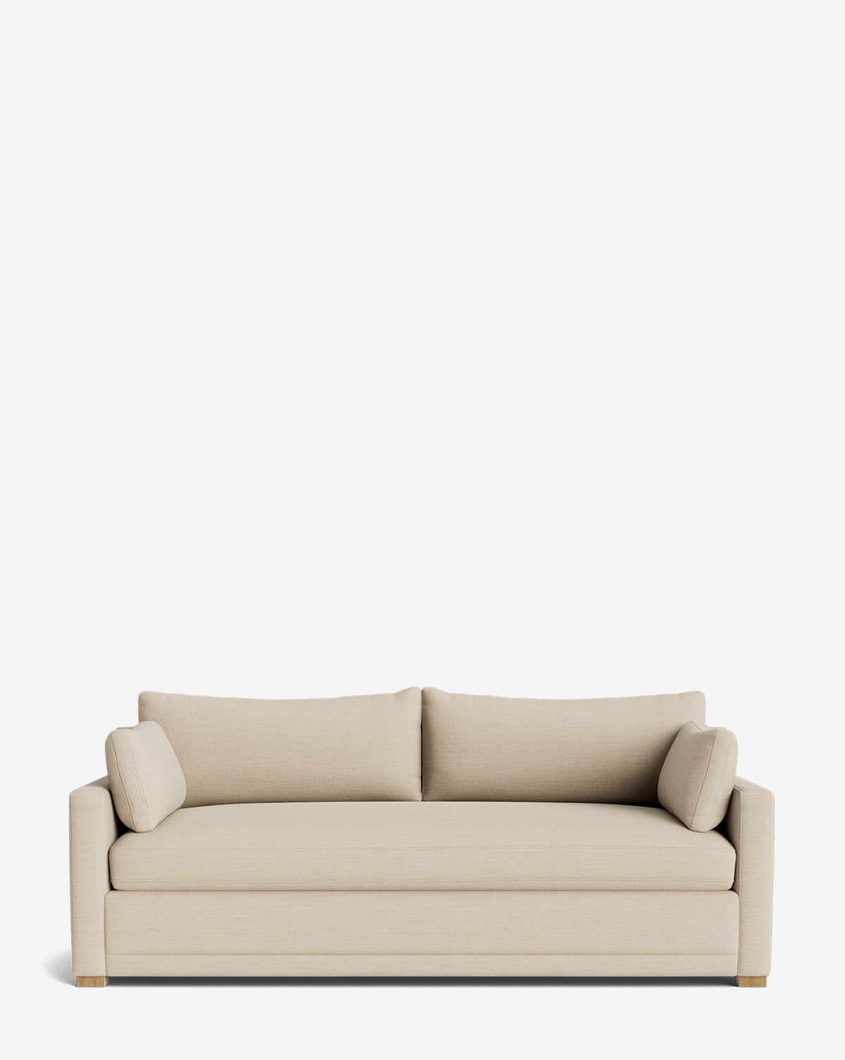 The Peterson Classic Upholstered Sofa (75 - 100) is a modern handcrafted beige sofa featuring straight arms, two plush back cushions, and two matching cylindrical side pillows, shown against a plain white background by McGee & Co.