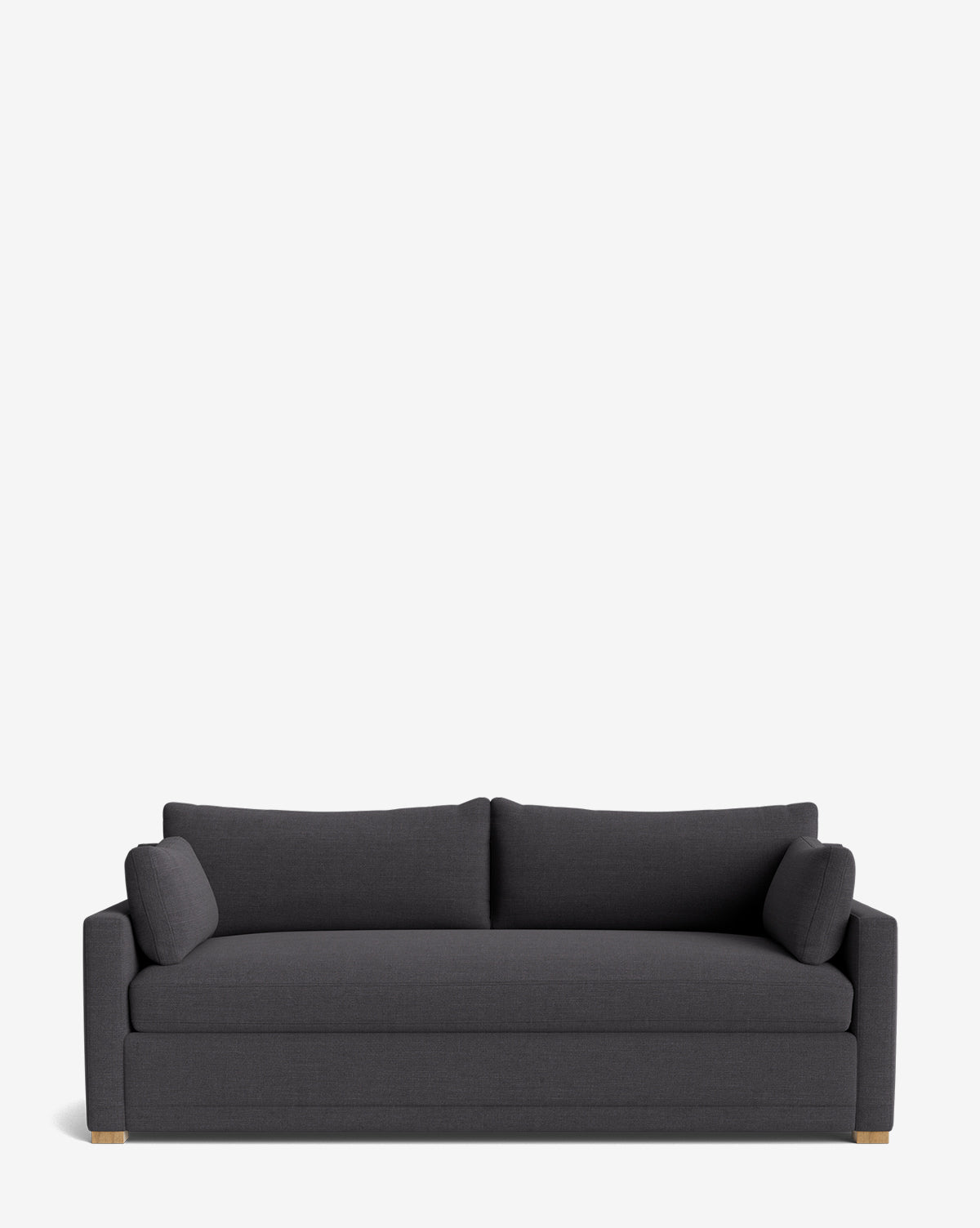 The Peterson Classic Upholstered Sofa (75 - 100) features a modern handcrafted design in dark gray, with plush seat cushions, two back cushions, and matching bolster pillows, shown on a plain white background by McGee & Co.
