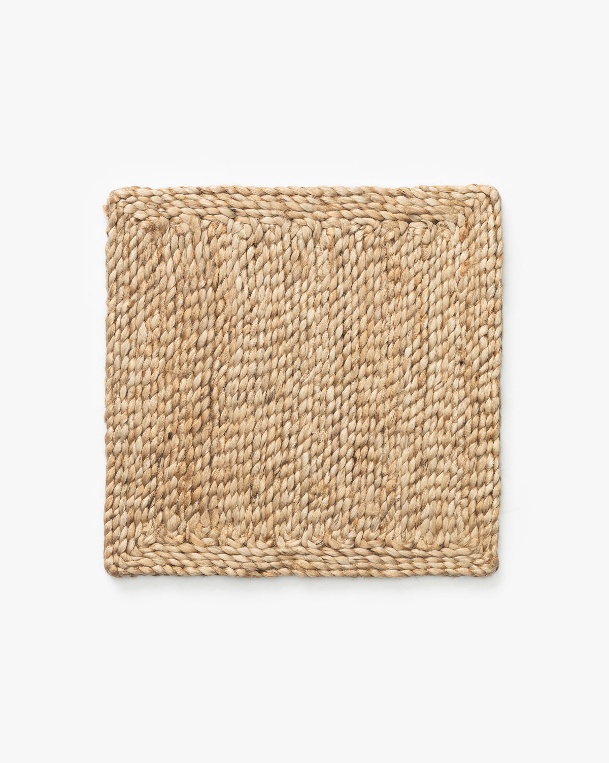 The Pieced Handwoven Jute Rug Swatch, showcased on a white background, brings rustic charm to your table setting with its handwoven jute fibers, by McGee & Co.
