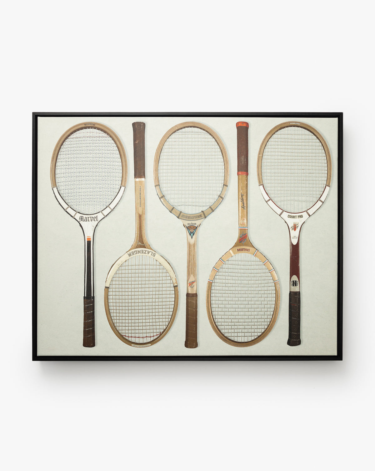 The Rackets 1 framed vintage wall art displays five uniquely designed wooden tennis rackets side by side against a neutral background, all enclosed in a classic black woodgrain frame, by McGee & Co.