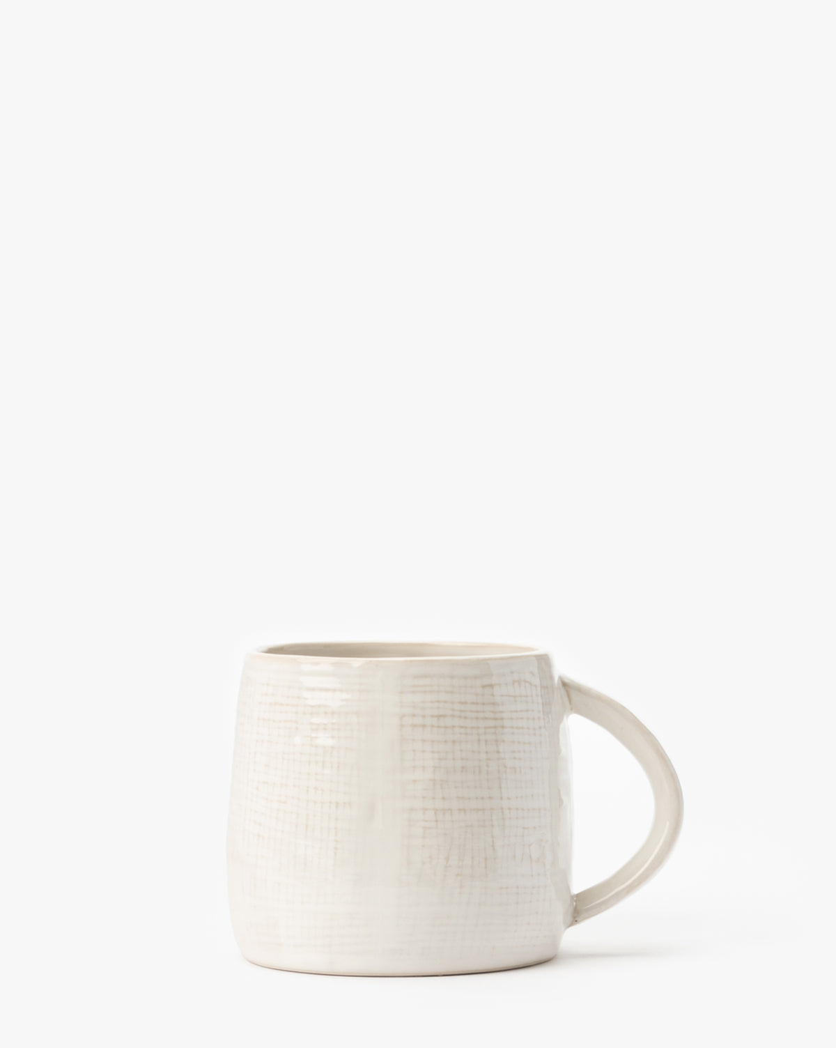 The Radlee Mug, an artisan ceramic piece with a subtle textured pattern, features a rounded shape and a sturdy handle on the right side, displayed against a plain white background by McGee & Co.