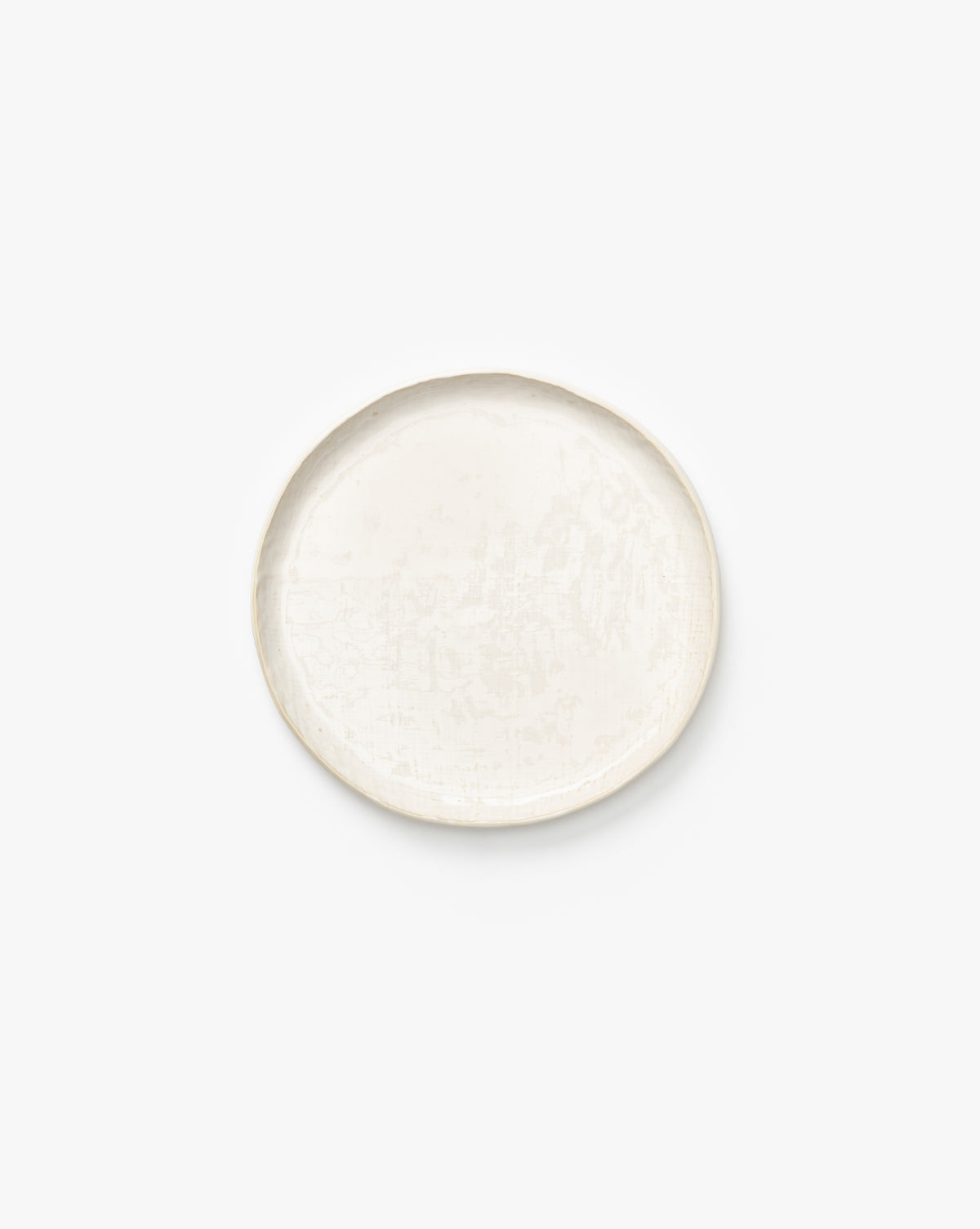 The Radlee Side Plate is a round, off-white ceramic plate with a slightly uneven edge, shown on a plain white background by McGee & Co.