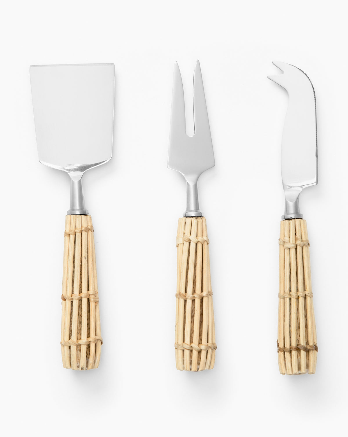 The Rattan Cheese Knives set features three utensils—a spatula, fork, and curved-tip knife—with silver blades and wicker-wrapped handles, arranged vertically on a white background. Ideal for elevating your next cheese board, by McGee & Co.