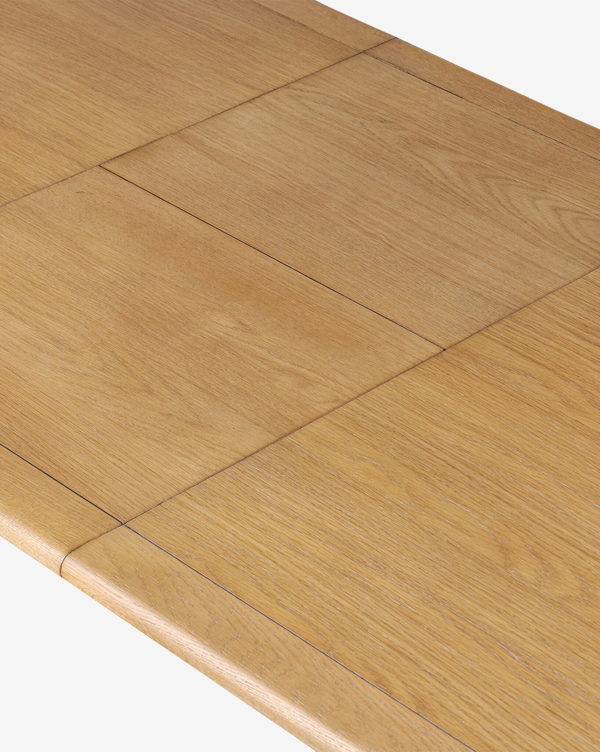 Close-up of the Redmond Extension Dining Table’s wooden surface, highlighting the seamless join of extension leaves, elegant Scandinavian design, visible wood grain, and a light brown finish—ideal for enhancing your dining room, by McGee & Co.