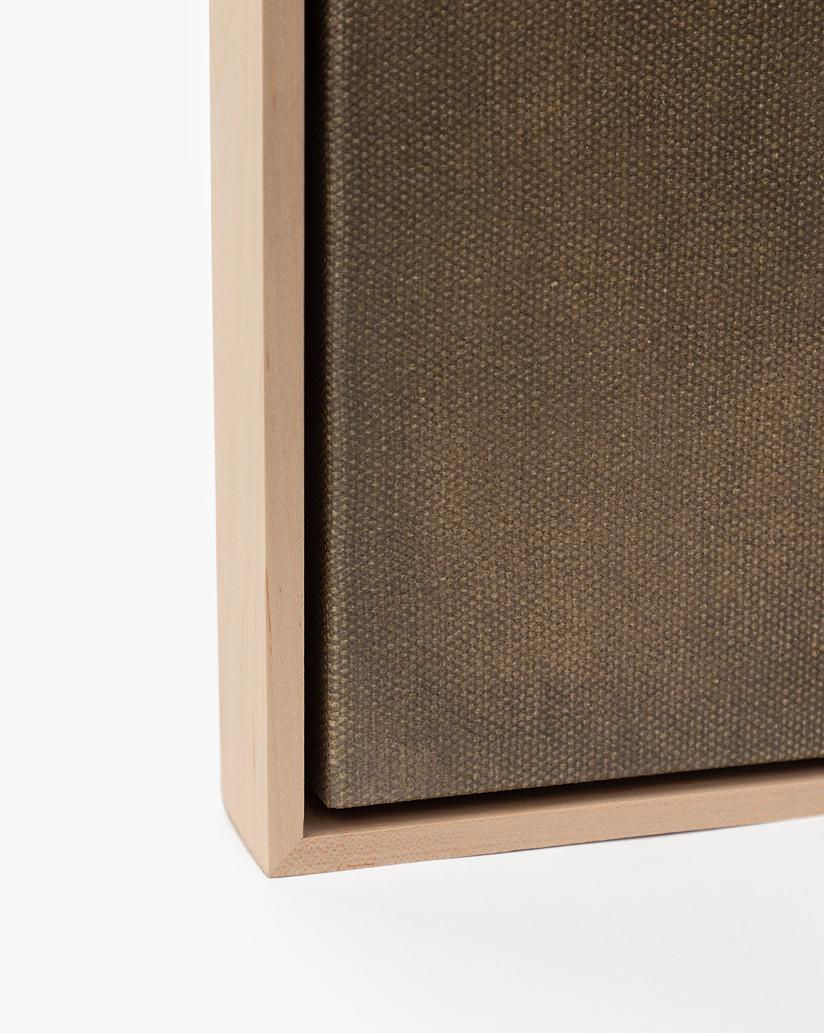 Close-up of the bottom left corner of Restored by Brittany Schulz, a museum-quality, framed canvas featuring a natural wood frame and textured brown surface against a white background, by McGee & Co.