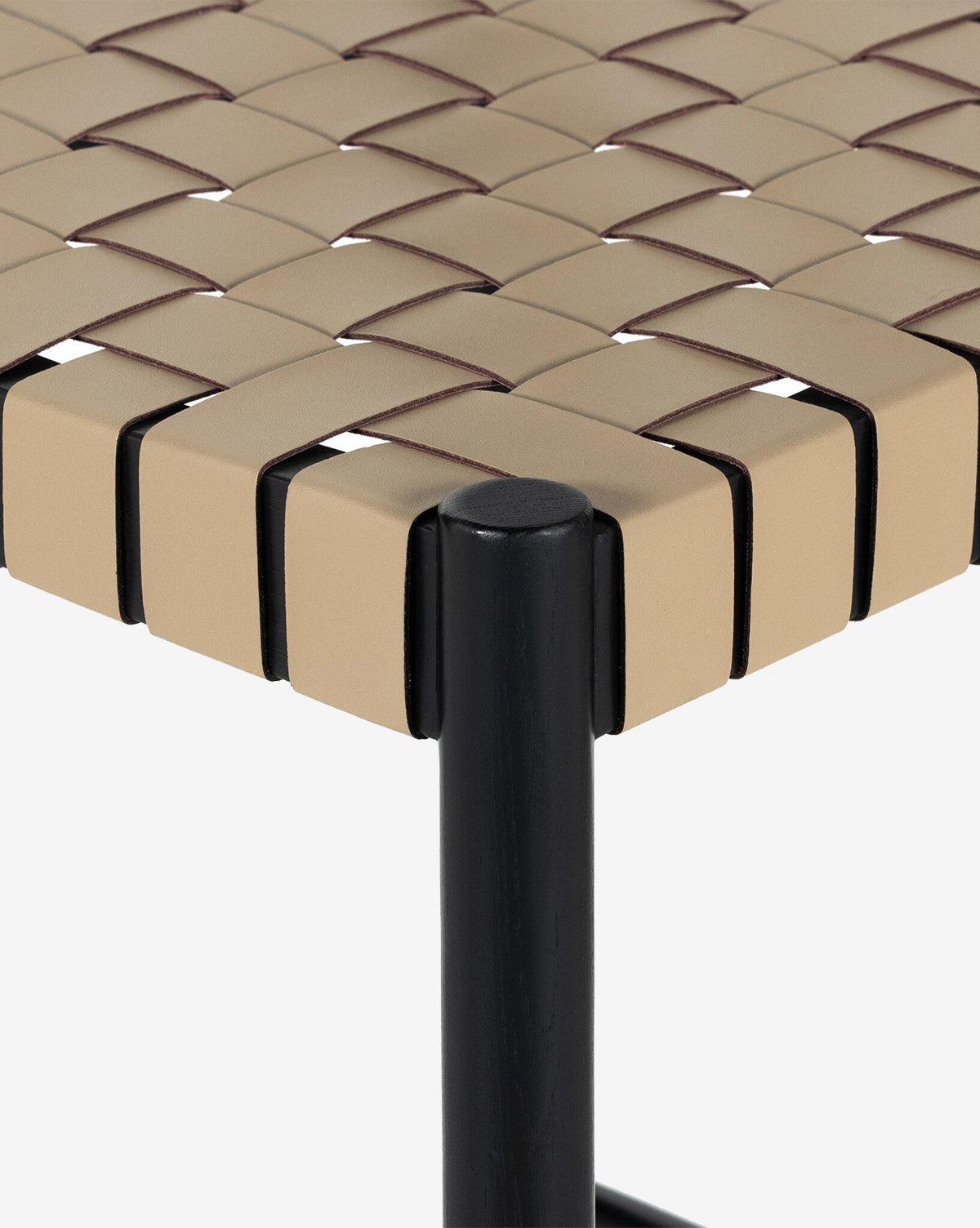 Close-up of the Robson Stool seat showcasing beige woven leather straps in a checkered pattern on a sleek black metal frame, by McGee & Co.