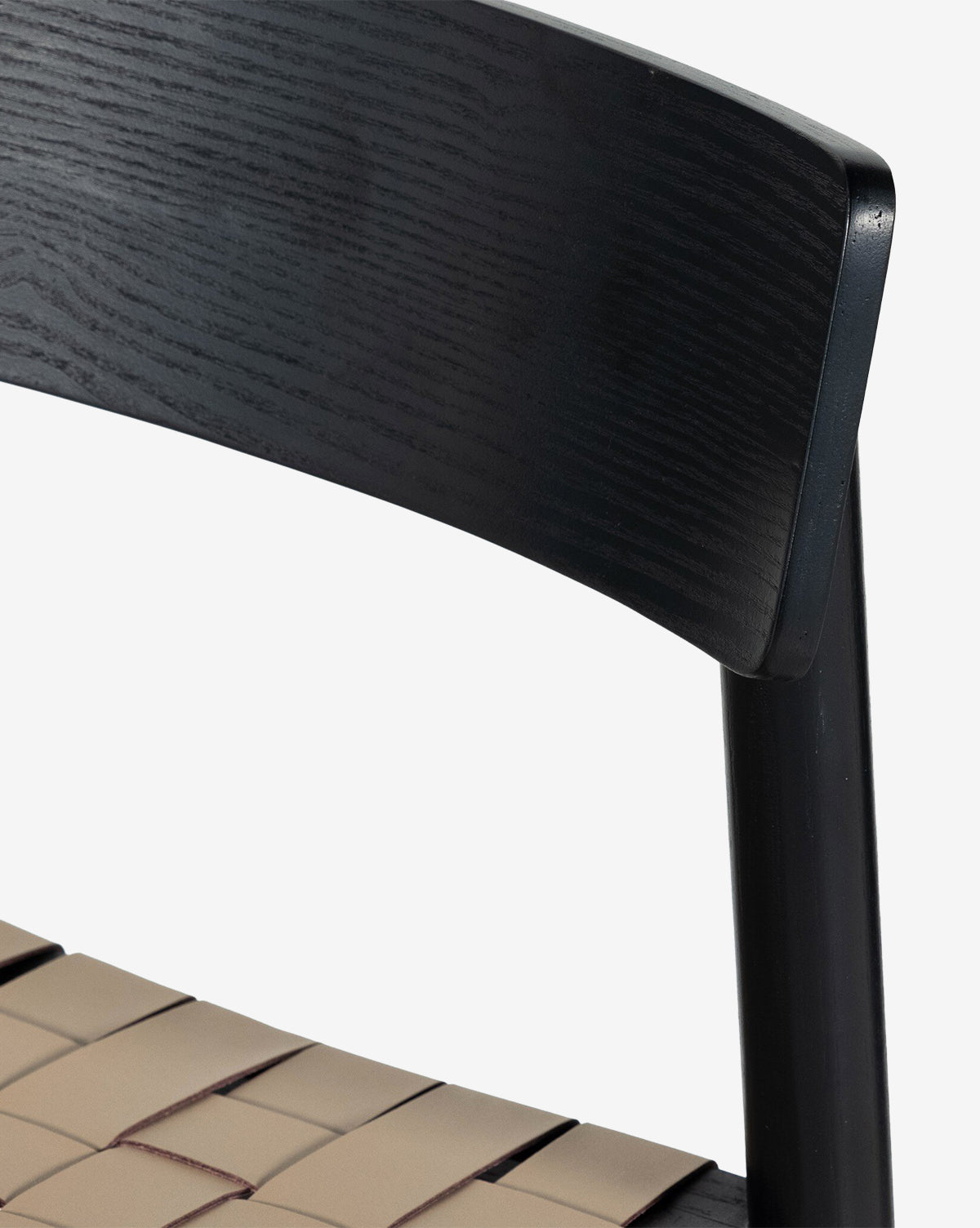 Close-up of the Robson Stool, a modern kitchen stool with a dark wooden backrest and beige woven leather seat straps, set against a plain white background, by McGee & Co.